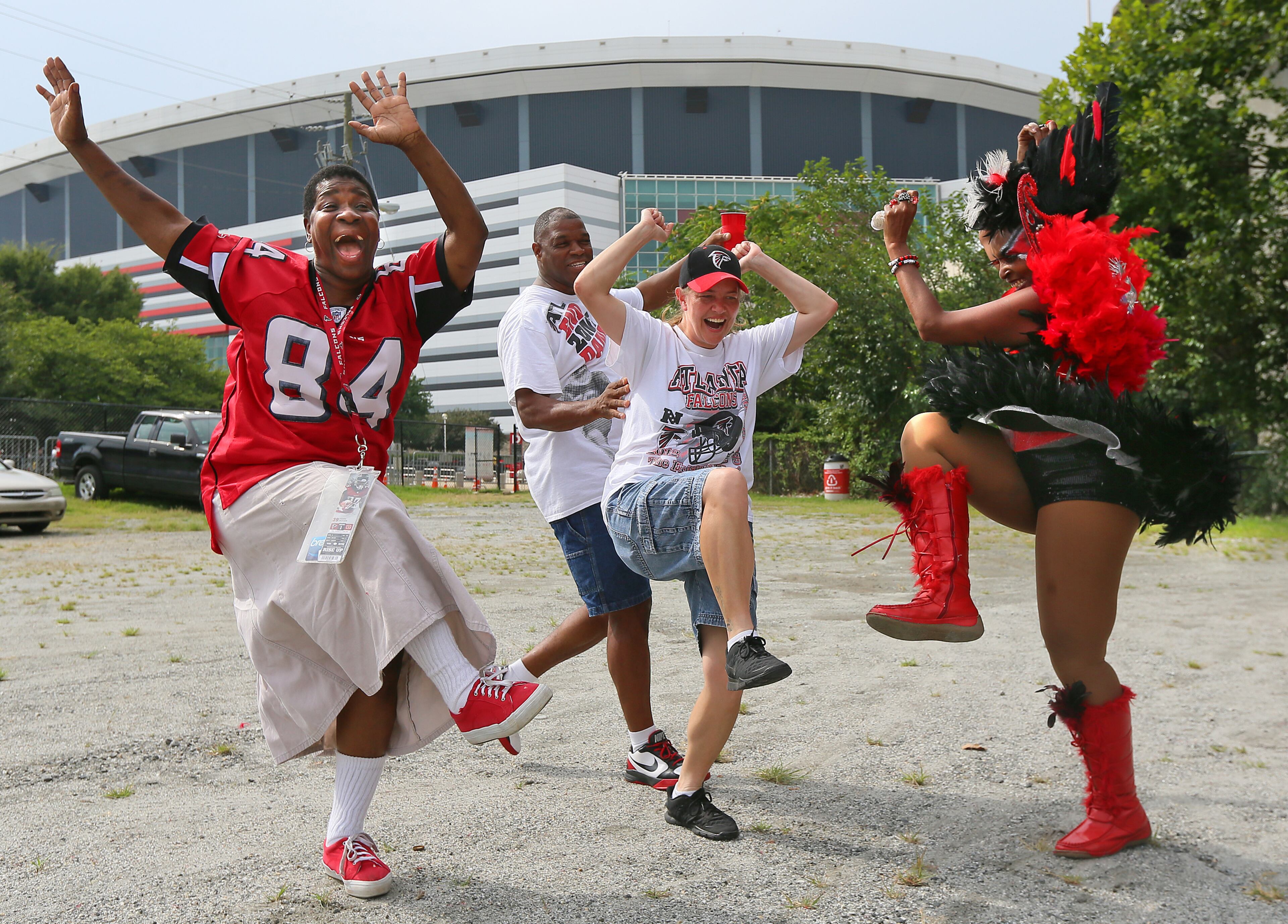 Members of "The Nest" tailgators get the season kicked off by kicking up their heels to some music outside the Georgia Dome before the Falcons NFL exhibition game against the Cincinnati Bengals on Thursday, August 8, 2013, in Atlanta. Diane White (from front left), Amy Moody, and Carolyn Freeman "The Original Bird Lady" get the party started.