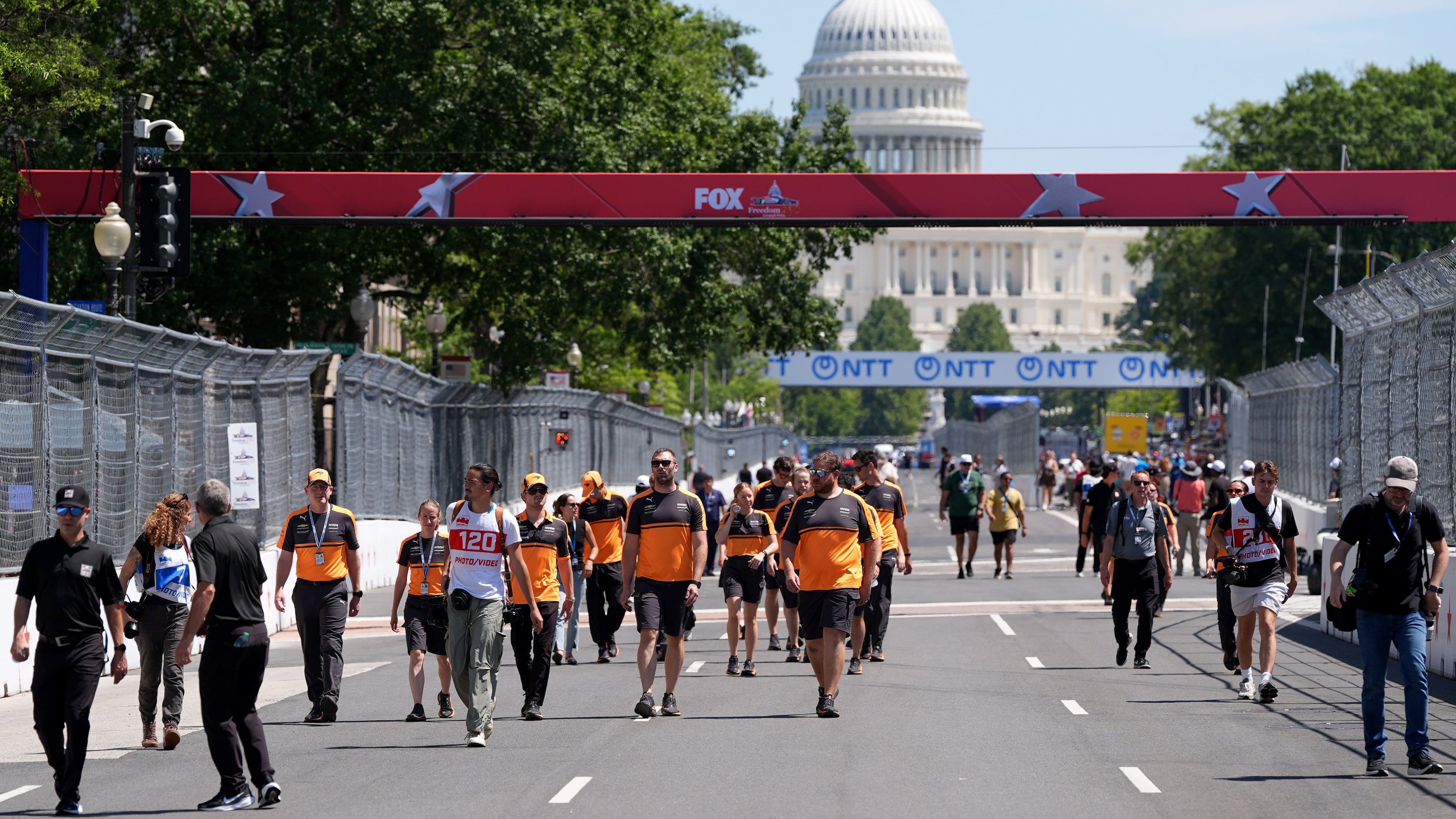 Racing teams walk the track before Sunday's Freedom 250 Grand Prix auto race, seen Friday, Aug. 21, 2026, in Washington. (AP Photo/Alex Brandon)