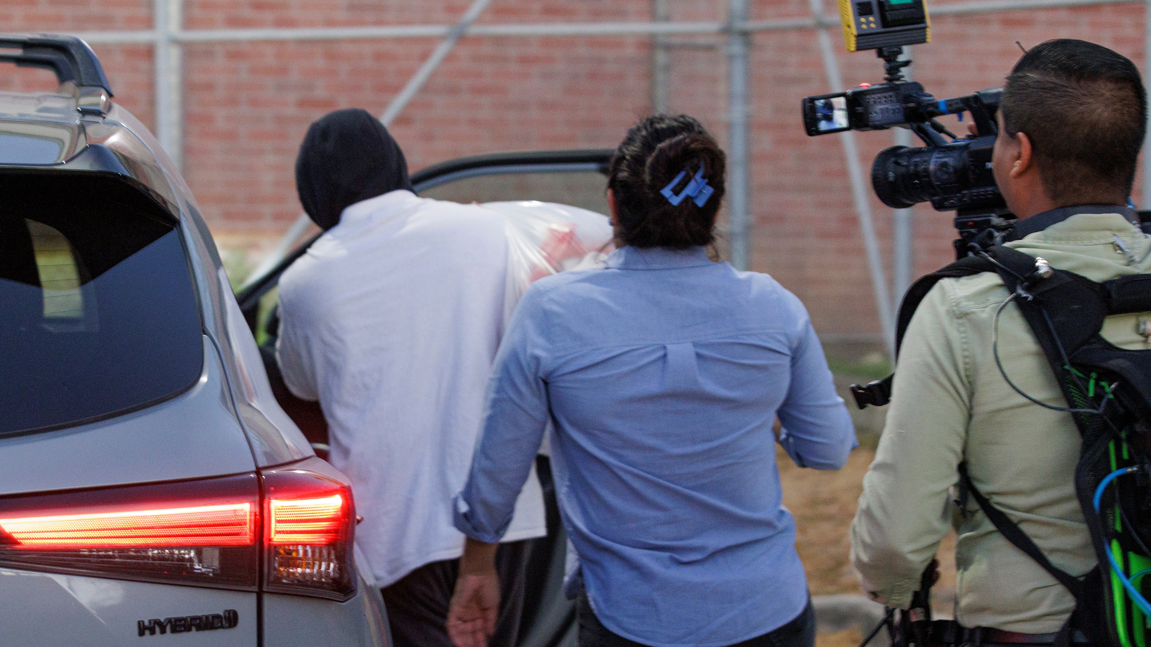 Immigration and Customs Enforcement officer Christian Castro gets into a car surrounded by news reporters moments after being released from the Carrizalez-Rucker Cameron County Detention Center in Brownsville, Texas on Thursday, Aug. 27, 2026. (AP Photo/Michael Gonzalez)