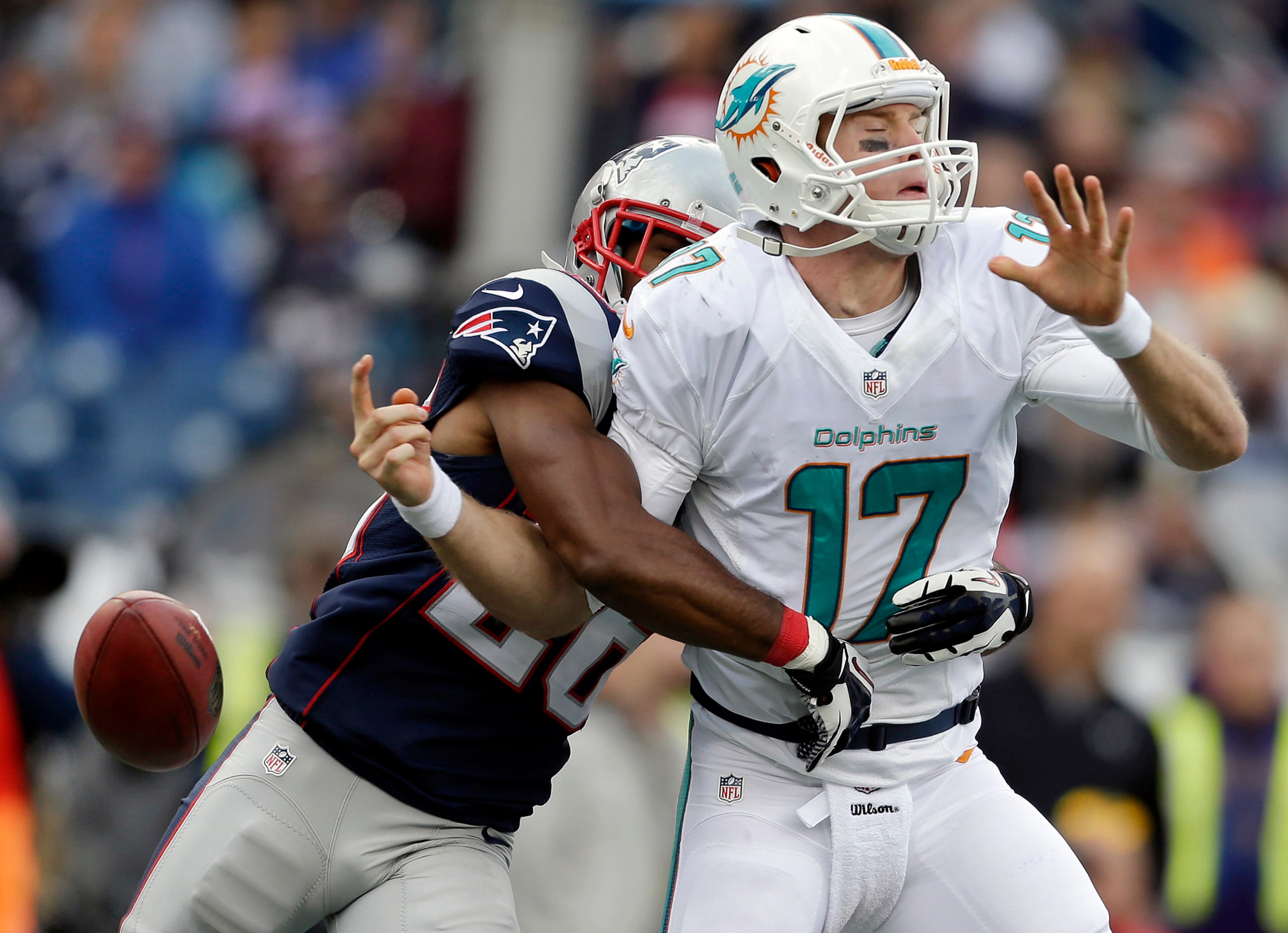 New England Patriots defensive back Logan Ryan, left, strips the ball from Miami Dolphins quarterback Ryan Tannehill (17) in the second half of an NFL football game in Foxborough, Mass. The New England Patriots beat the Miami Dolphins 27-17. (AP Photo/Steven Senne)