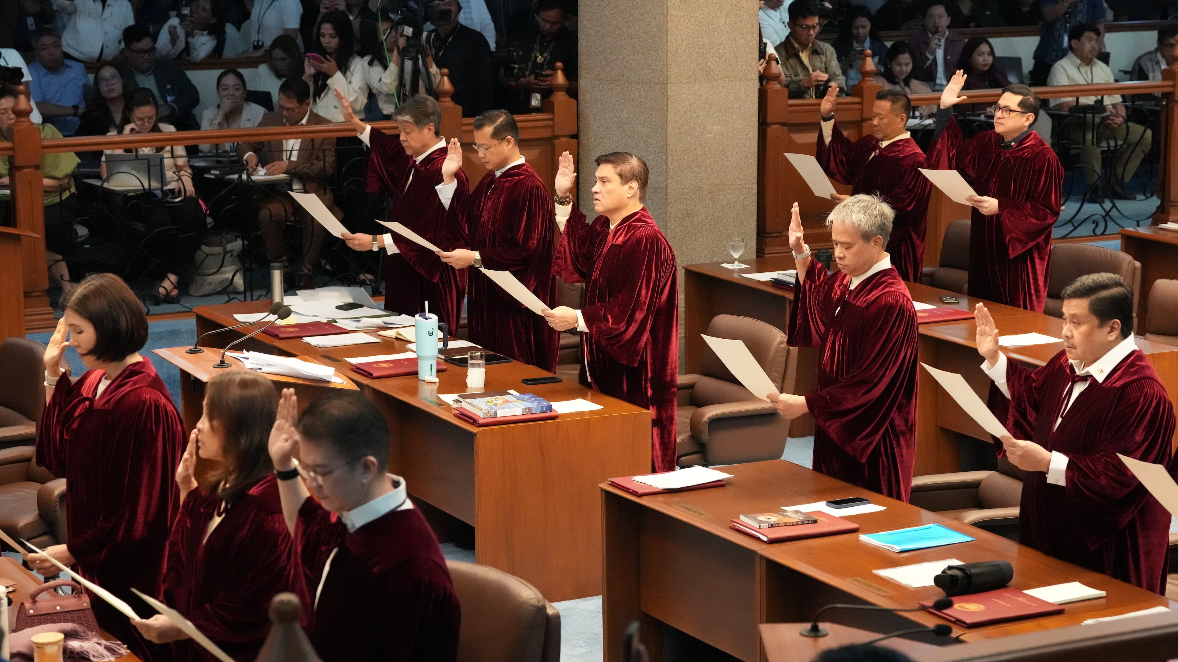 Philippine senators take oath as they convene as an impeachment court for the trial of Vice President Sara Duterte at the Philippine senate, Monday, May 18, 2026, in Pasay, Philippines. (AP Photo/Aaron Favila)