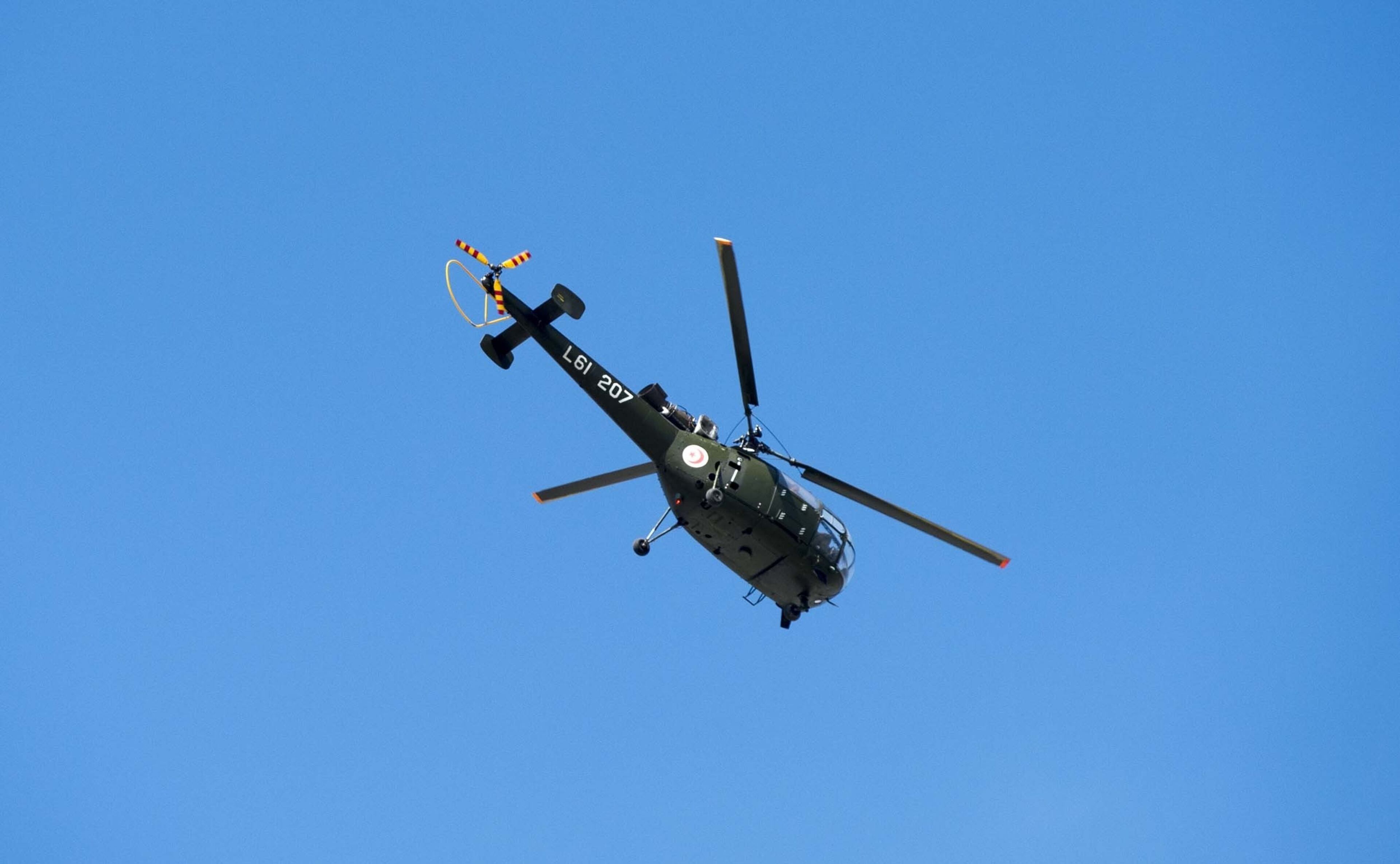 TUNIS, TUNISIA - MARCH 18: A police helicopter circling over the National Bardo Museum, near the country's parliament in Tunis, when gunmen take an unknown number of tourists hostage on Wednesday, March 18, 2015. At least eight people, including six foreign tourists, were killed in the attack by unidentified gunmen on the museum in the Tunisian capital, the Interior Ministry said. (Photo by Ahmet Izgi/Anadolu Agency/Getty Images)