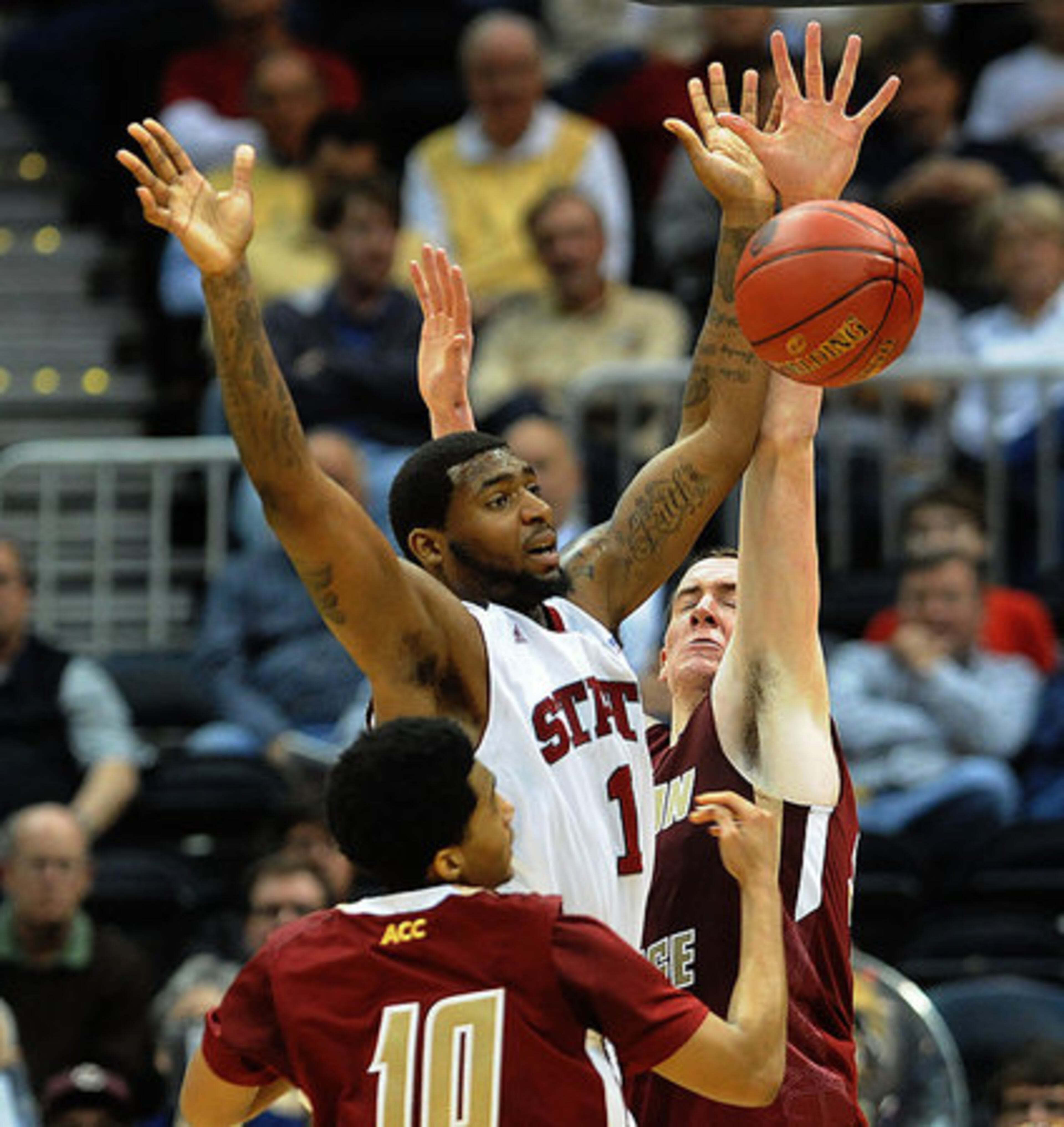 NC State's Richard Howell has the ball stripped by Boston College's Dennis Clifford.