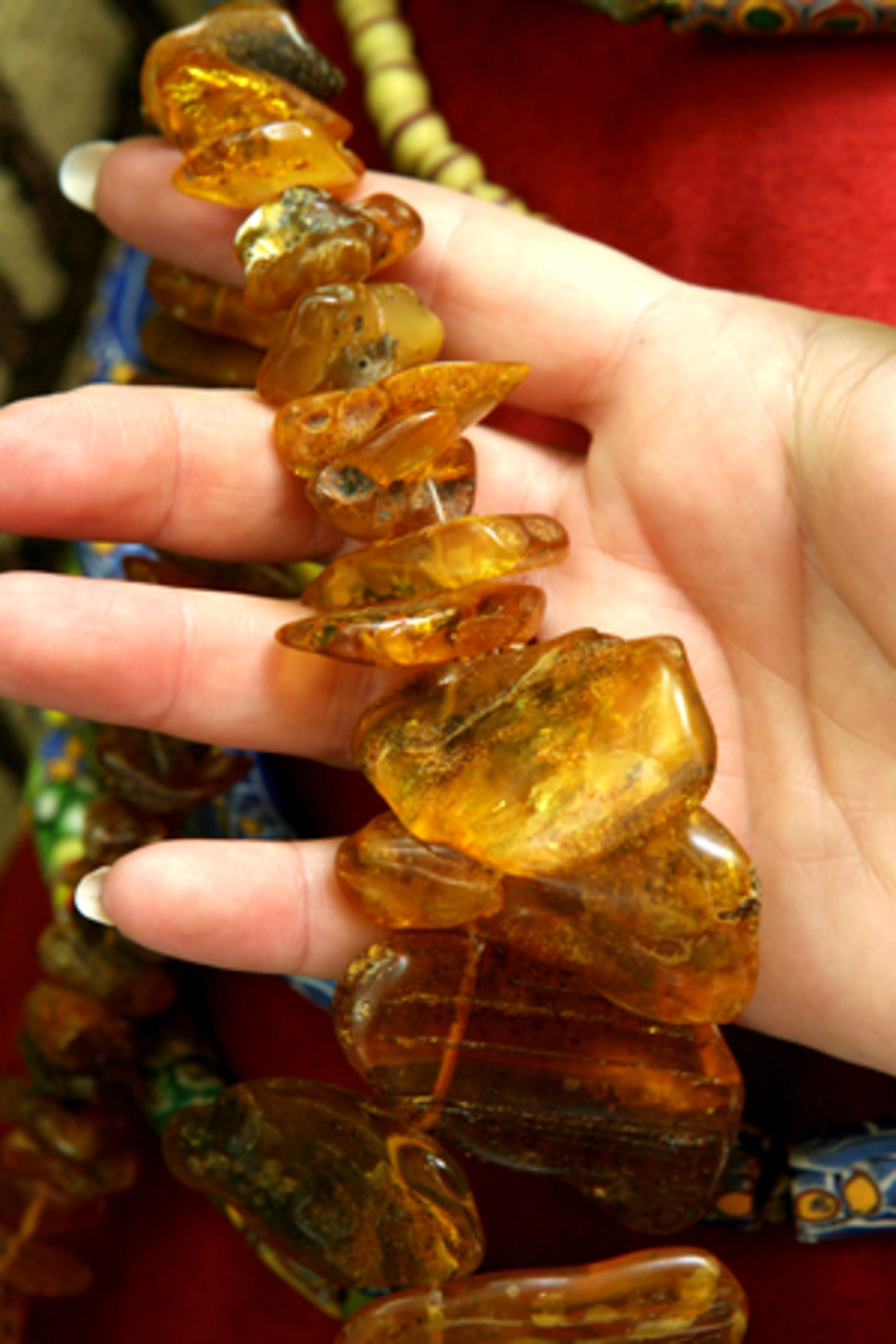 Susan Rochfort holds a string of amber beads. More than 230 pieces of African art and artifacts from the collection owned by Susan and her husband William are on display in Duluth. The collection features fine bronze castings, elaborate masks, richly woven textiles, intricate adornments such as headdresses and beads and decorated utilitarian objects for everyday use.