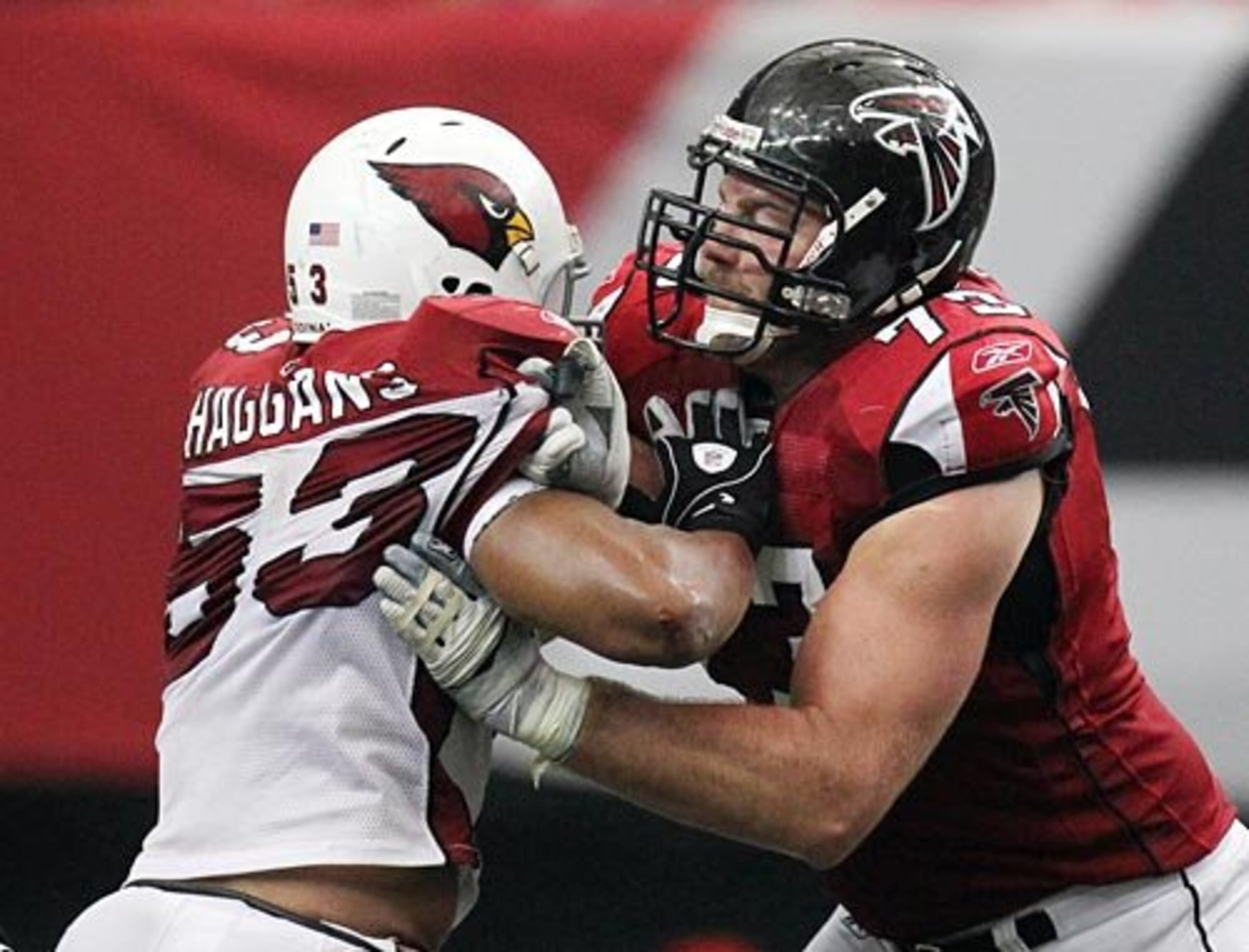 Falcons offensive lineman Harvey Dahl blocks Arizona Cardinals linebacker Clark Haggans out of the way on a running play during 2nd half action.