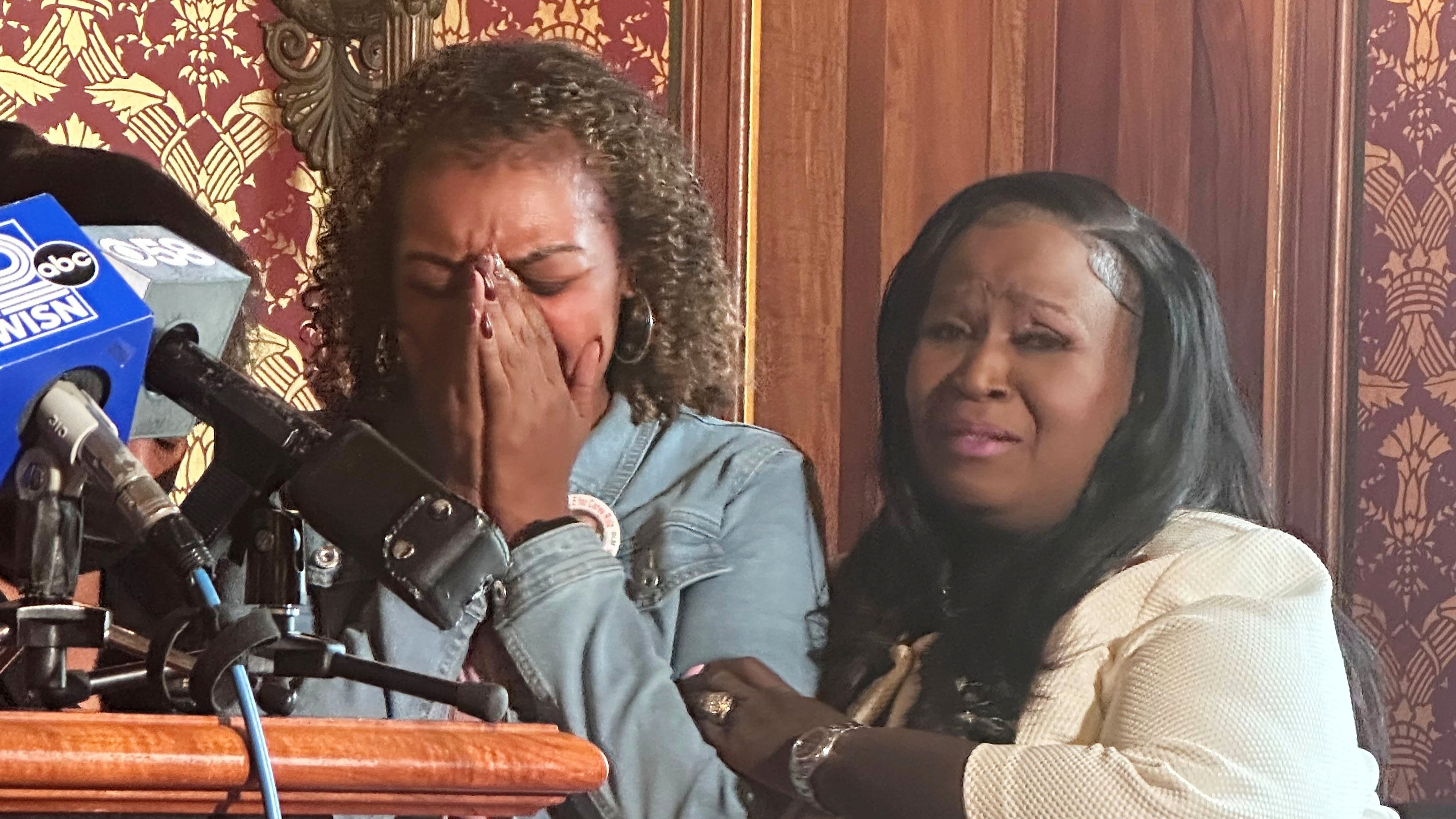 Veronica Ruiz, the sister of Corey Ruiz, who was killed by Madison police, breaks down in tears and is comforted by Wisconsin state Rep. Shelia Stubbs, D-Madison, right, Friday, July 24, 2026, in Madison, Wis. (AP Photo/Scott Bauer)