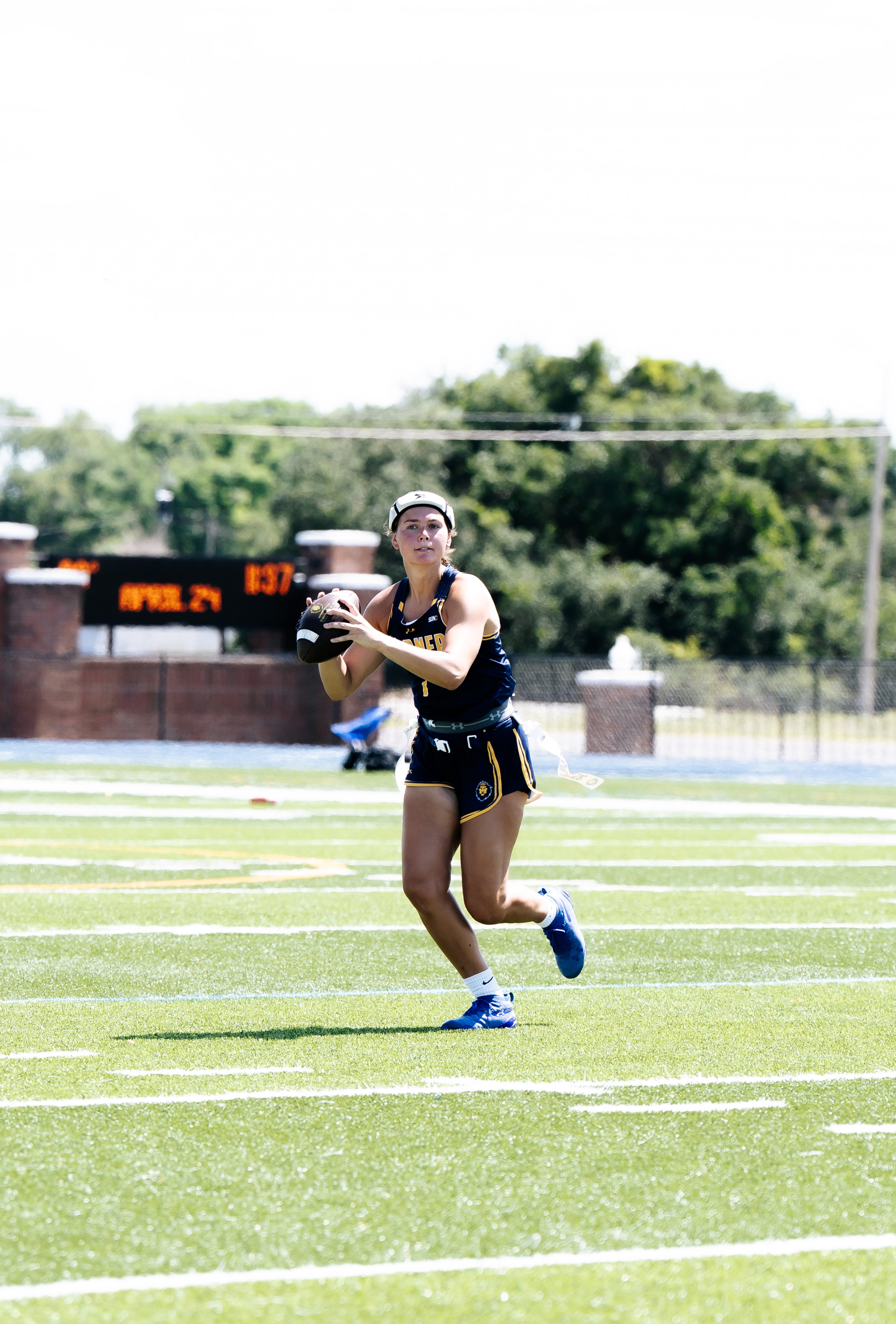 Warner University quarterback Kathryn Hutchinson — pictured preparing to pass in a game earlier this season — was named a first-team NAIA All-American for her record-setting play. Hutchinson has thrown an NAIA-record 152 touchdown passes with just 10 interceptions this season. (Courtesy of Timothy Mabins/Warner University)