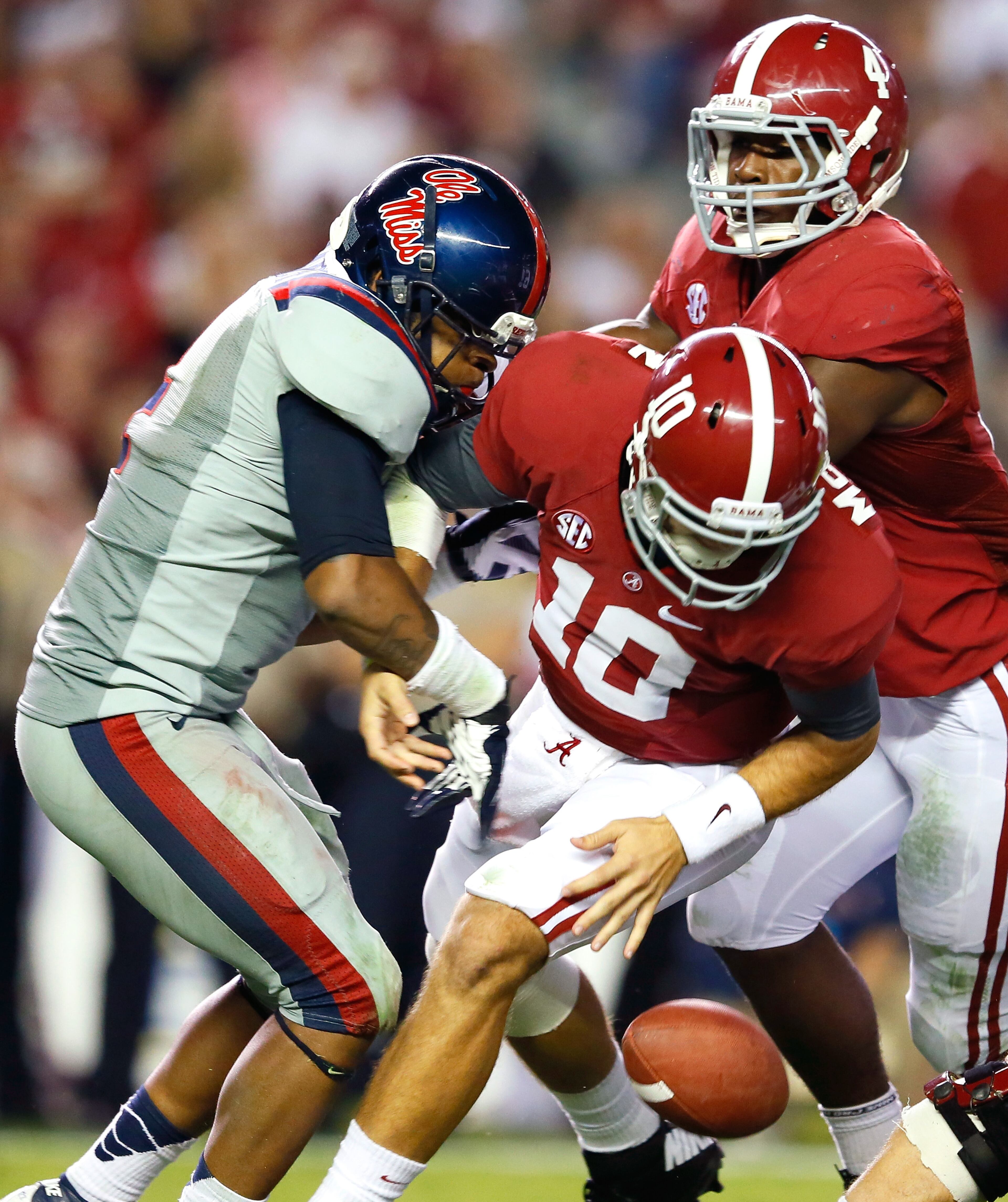 Denzel Nkemdiche (4) of Mississippi strips the ball from AJ McCarron of Alabama at Bryant-Denny Stadium on September 29, 2012 in Tuscaloosa, Alabama.