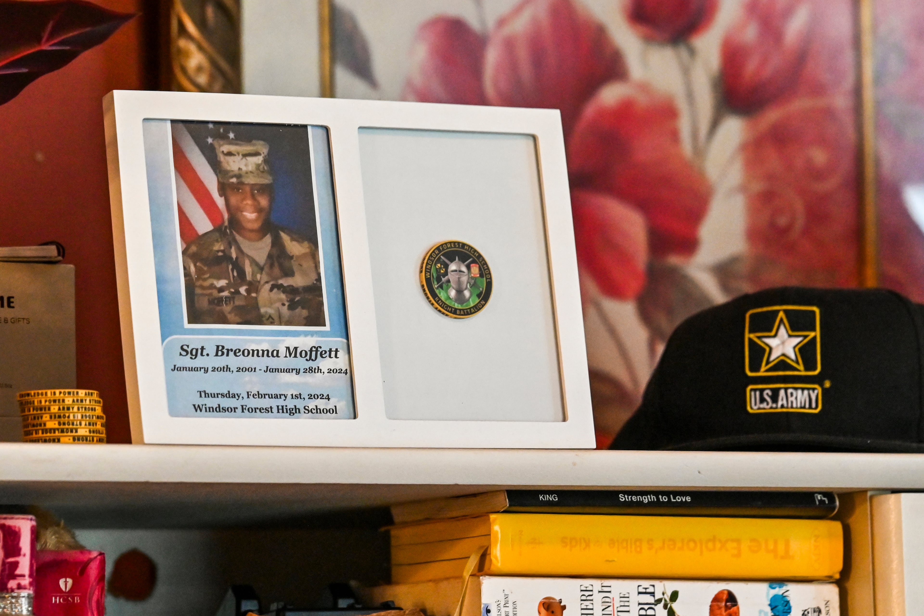 Mementos of Sgt. Breonna Moffett line a shelf at Francine and Percell Moffett's family home in Savannah. (Sarah Peacock for the AJC)