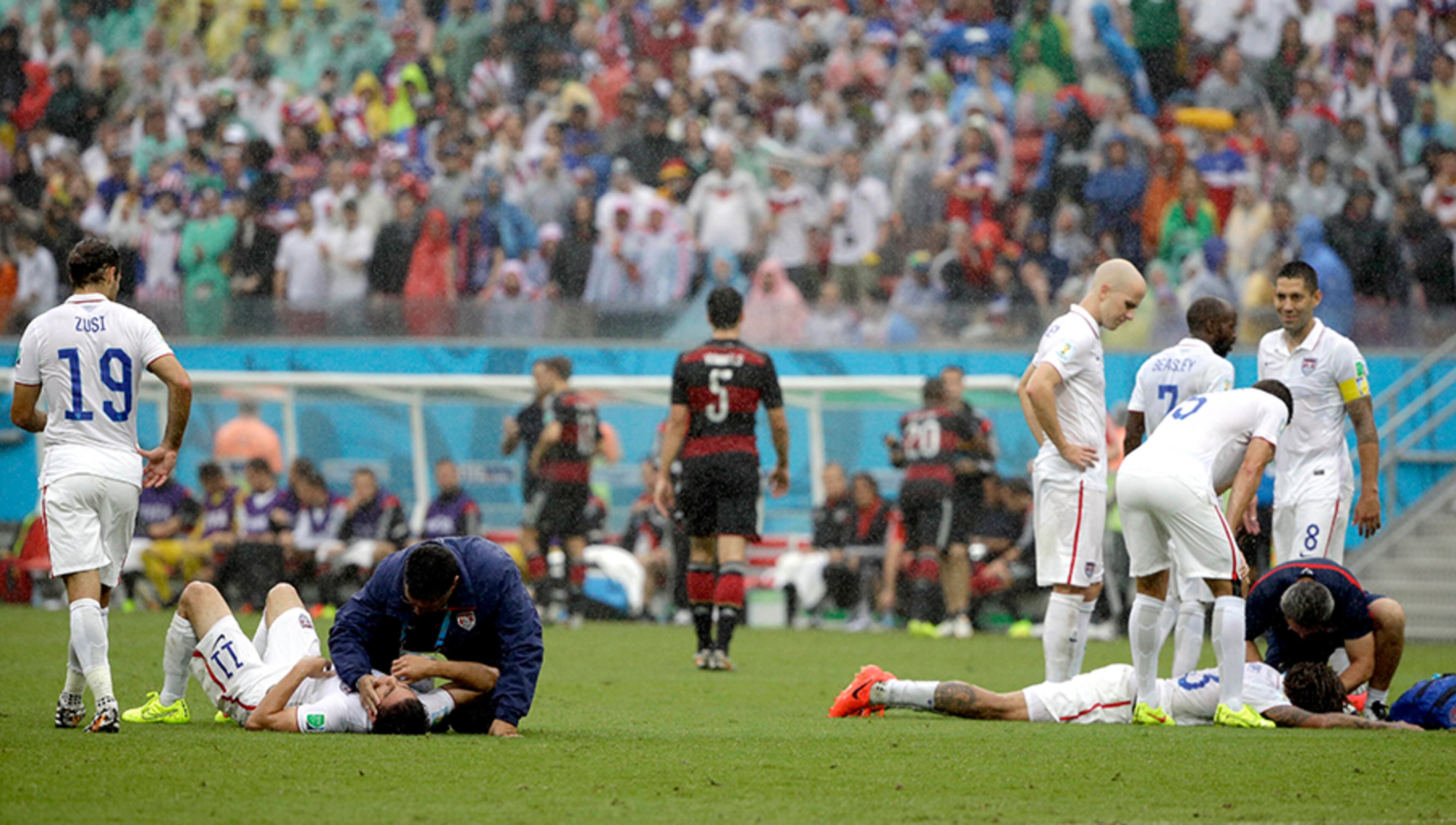 United States' Alejandro Bedoya (left) and United States' Jermaine Jones are tended to by medical personnel after colliding during the group G World Cup soccer match between the USA and Germany at the Arena Pernambuco in Recife, Brazil, Thursday, June 26, 2014.
