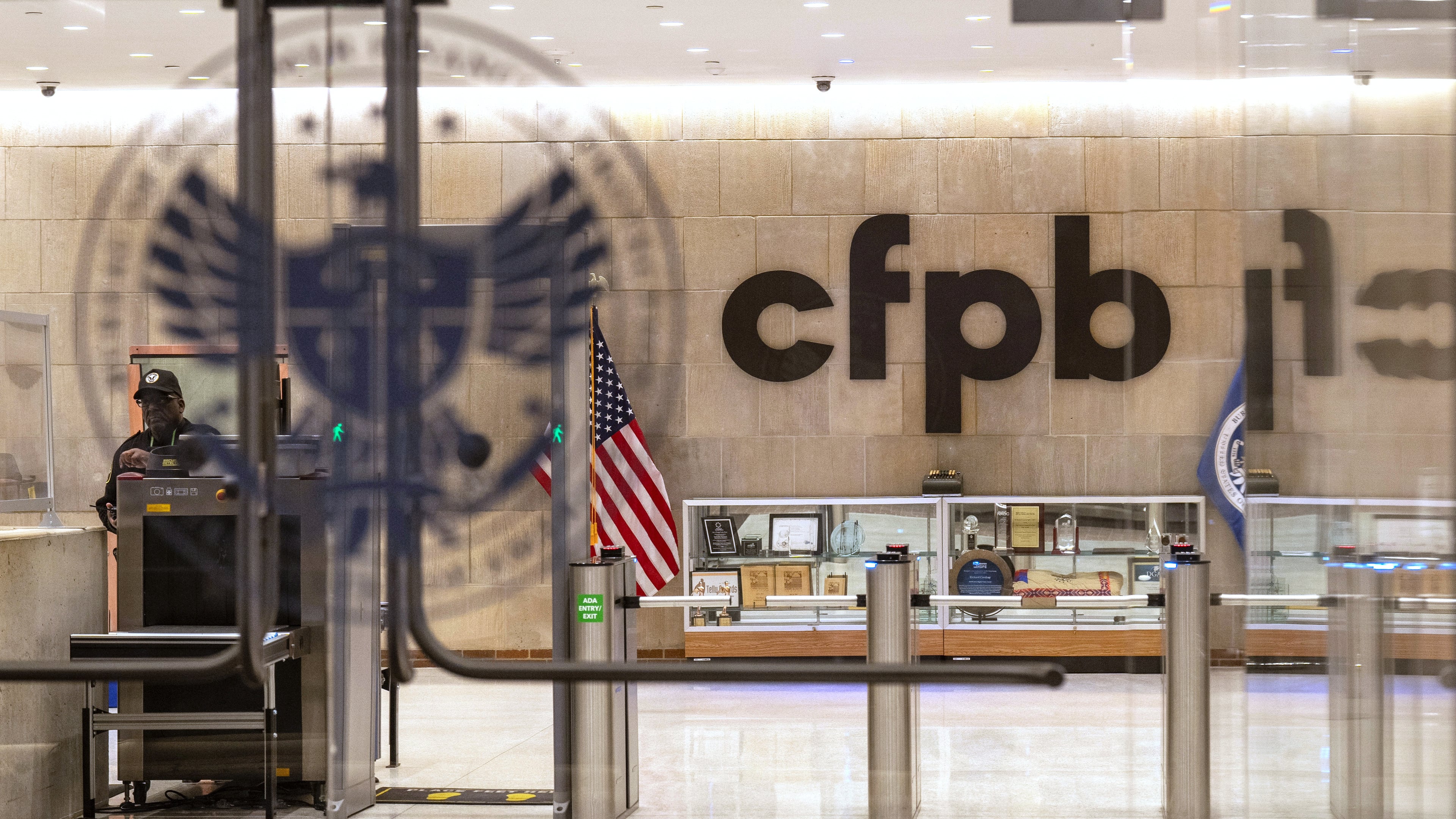 FILE - A security officer works inside of the Consumer Financial Protection Bureau (CFPB) building headquarters, Feb. 10, 2025, in Washington. (AP Photo/Jacquelyn Martin, File)