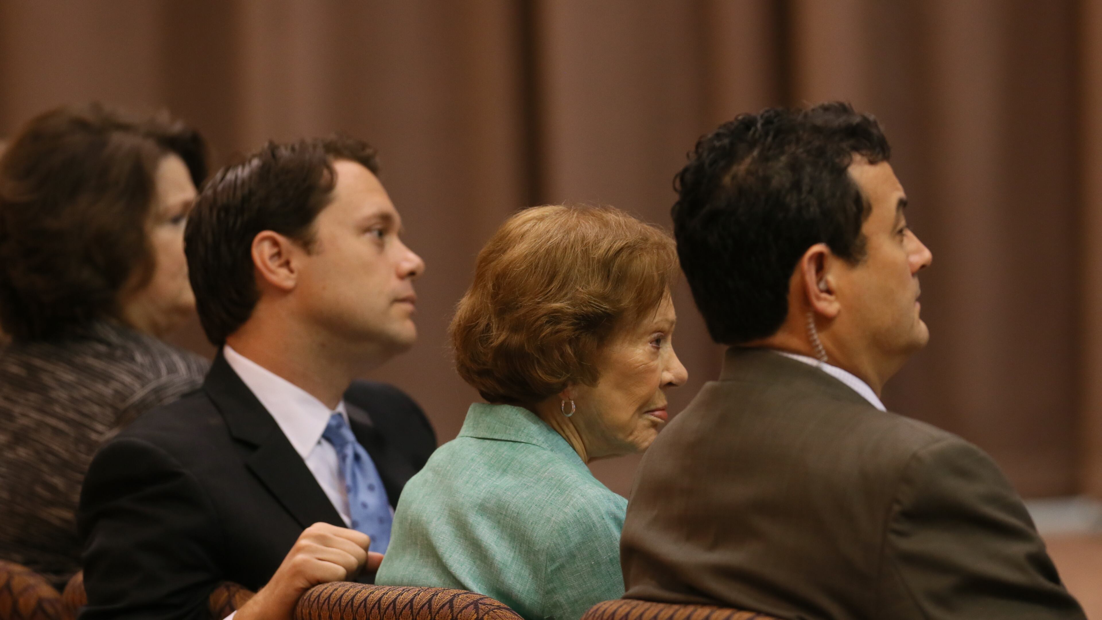 Rosalynn Carter, wife of Jimmy Carter, and his grandson Jason Carter listen during a news conference as the former president discusses his cancer treatment.