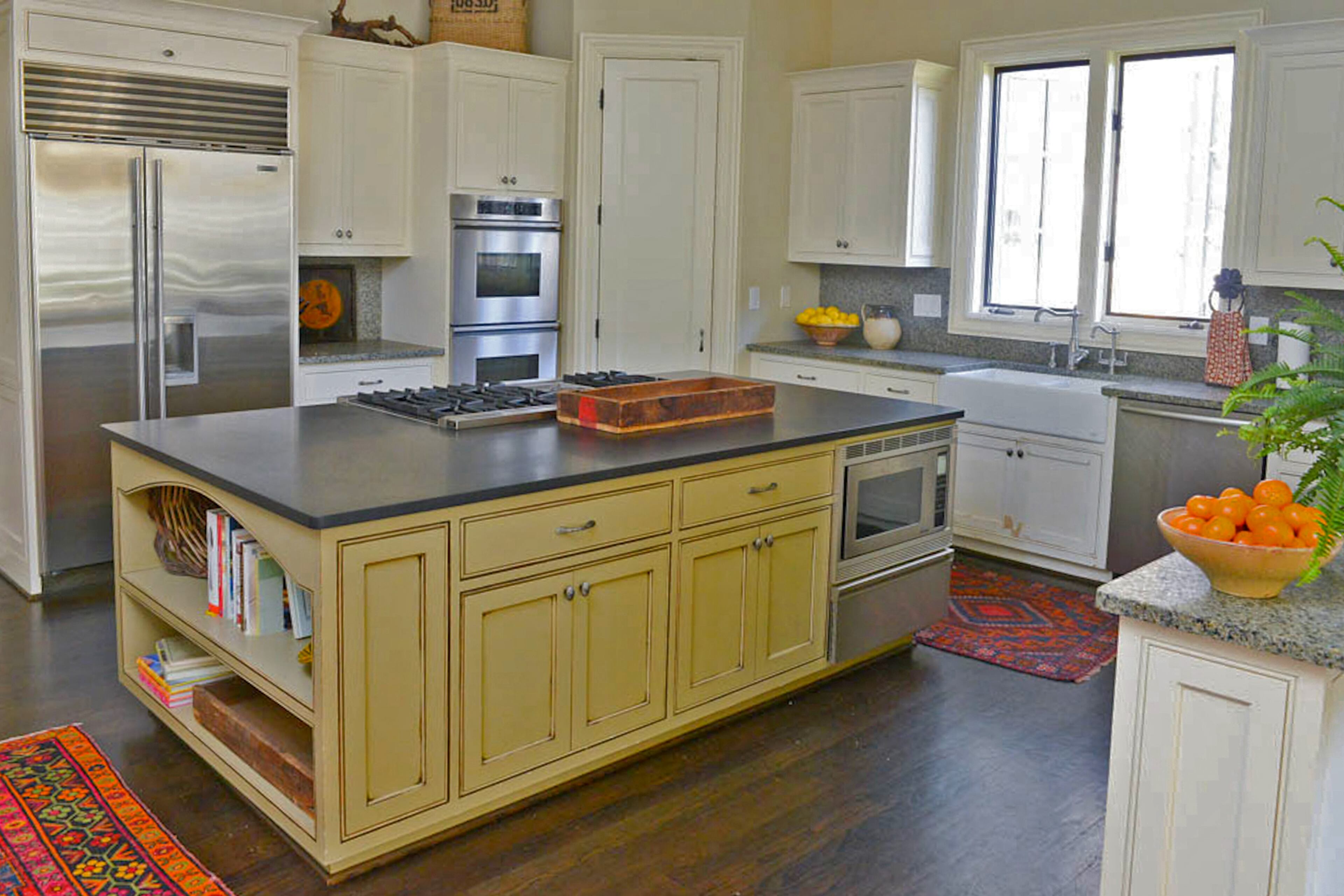 Jeanmarie Quarterman's well-appointed kitchen includes a Viking stove, Dacor double oven and microwave “all stainless steel" and a farmhouse sink by Kohler. The microwave is built into the expansive center island, which is painted in an antique cream and includes storage and shelving for cookbooks and other accessories.