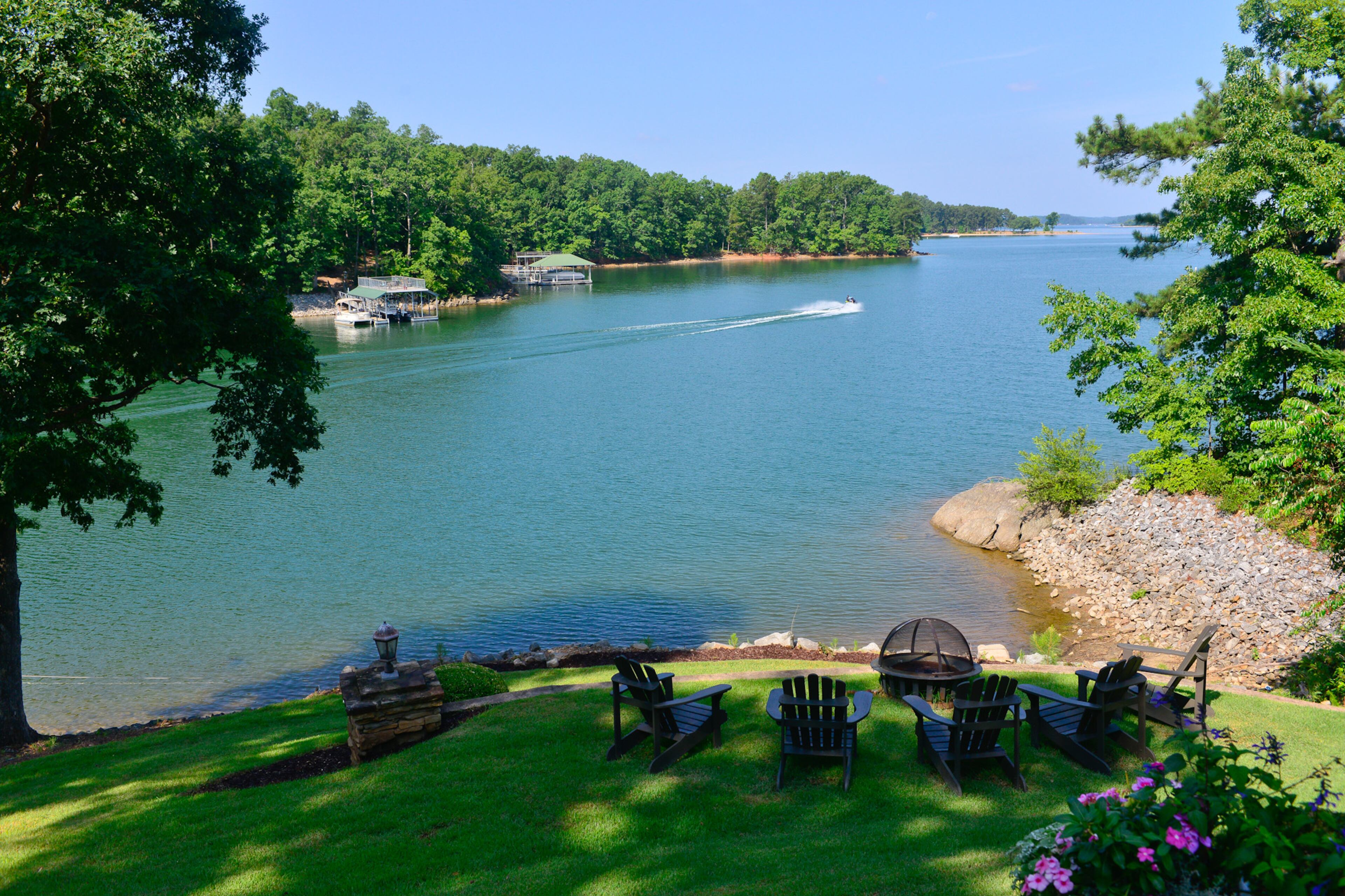 The waterfront property includes a gas fire pit with Adirondack chairs overlooking Lake Lanier from the deepwater lot. Text by Lori Johnston and Shannon Adams/Fast Copy News Service. Christopher Oquendo Photography/AJC File