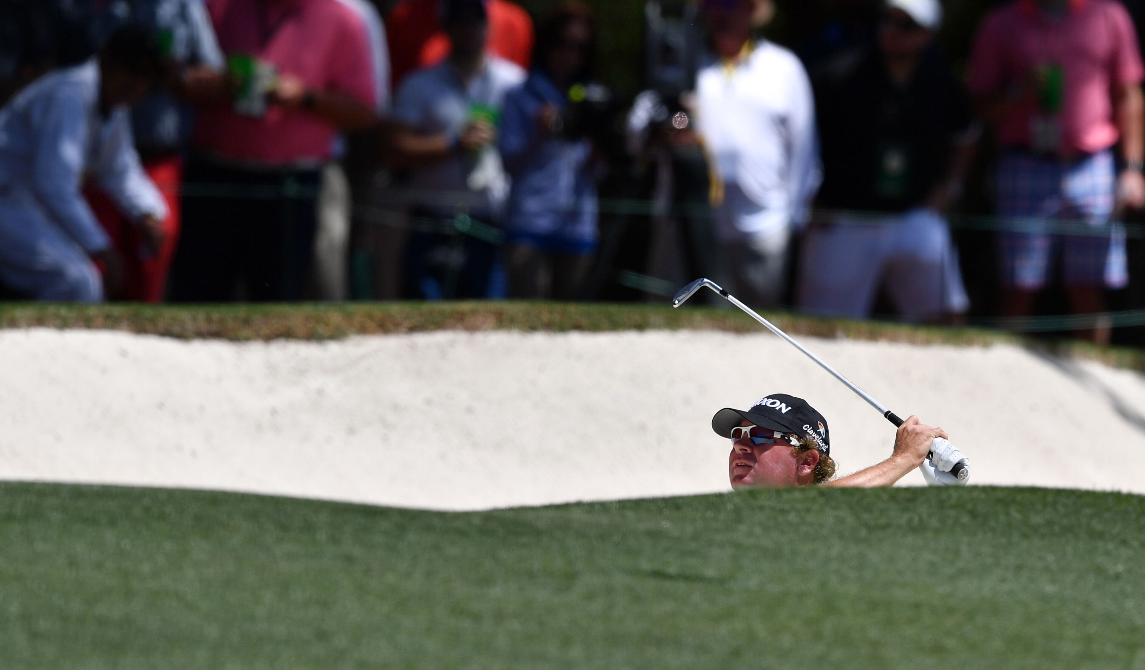 William McGirt plays his shot from the 1st fairway bunker.