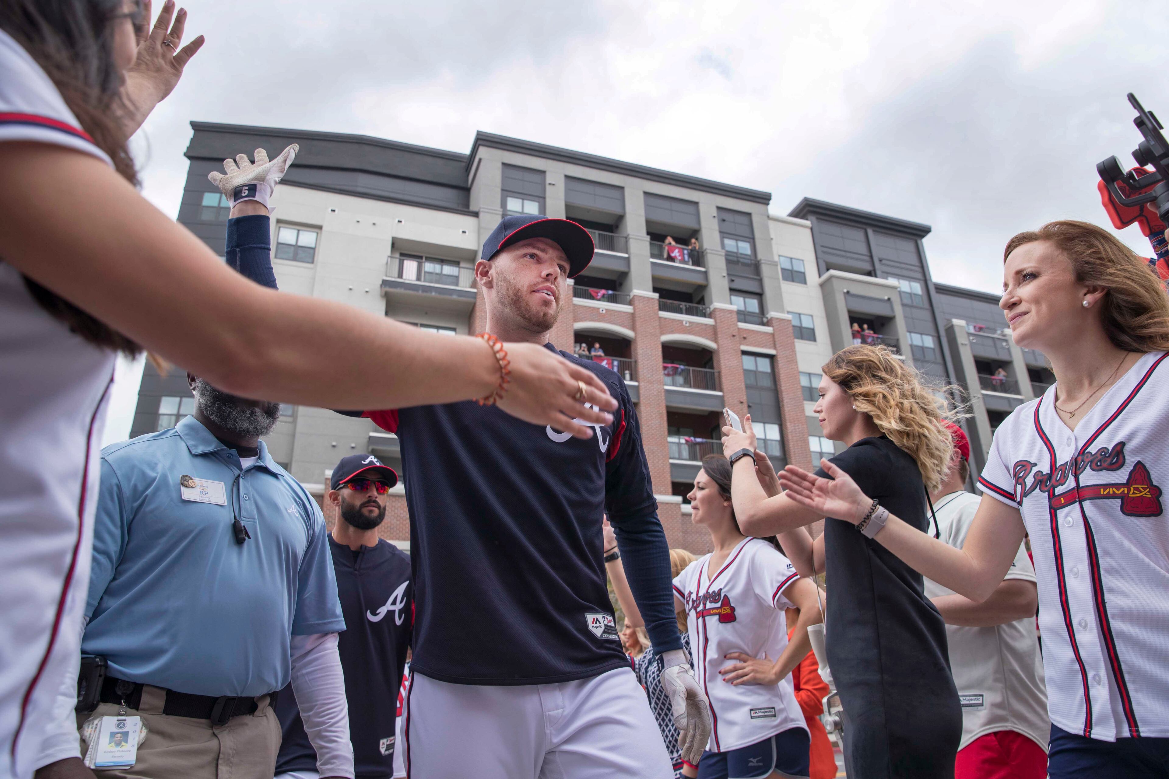 Freddie Freeman exchanges high fives with fans during Thursday's Brave Walk at SunTrust Park. (ALYSSA POINTER/ALYSSA.POINTER@AJC.COM)