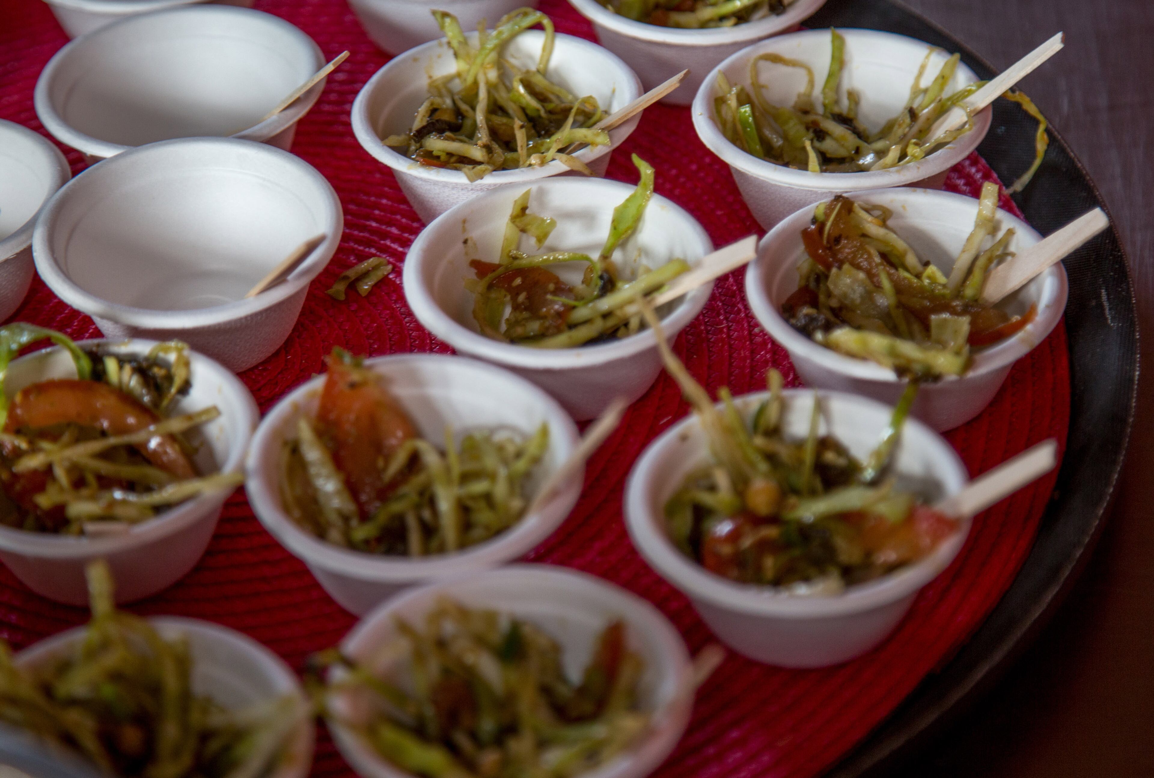 Samples of the Fermented Tea Salad made by Clarkston High School students are prepared to be handed out during the Refugee Recipe Celebration at the Atlanta Botanical Garden Sunday, June 24, 2018. STEVE SCHAEFER / SPECIAL TO THE AJC