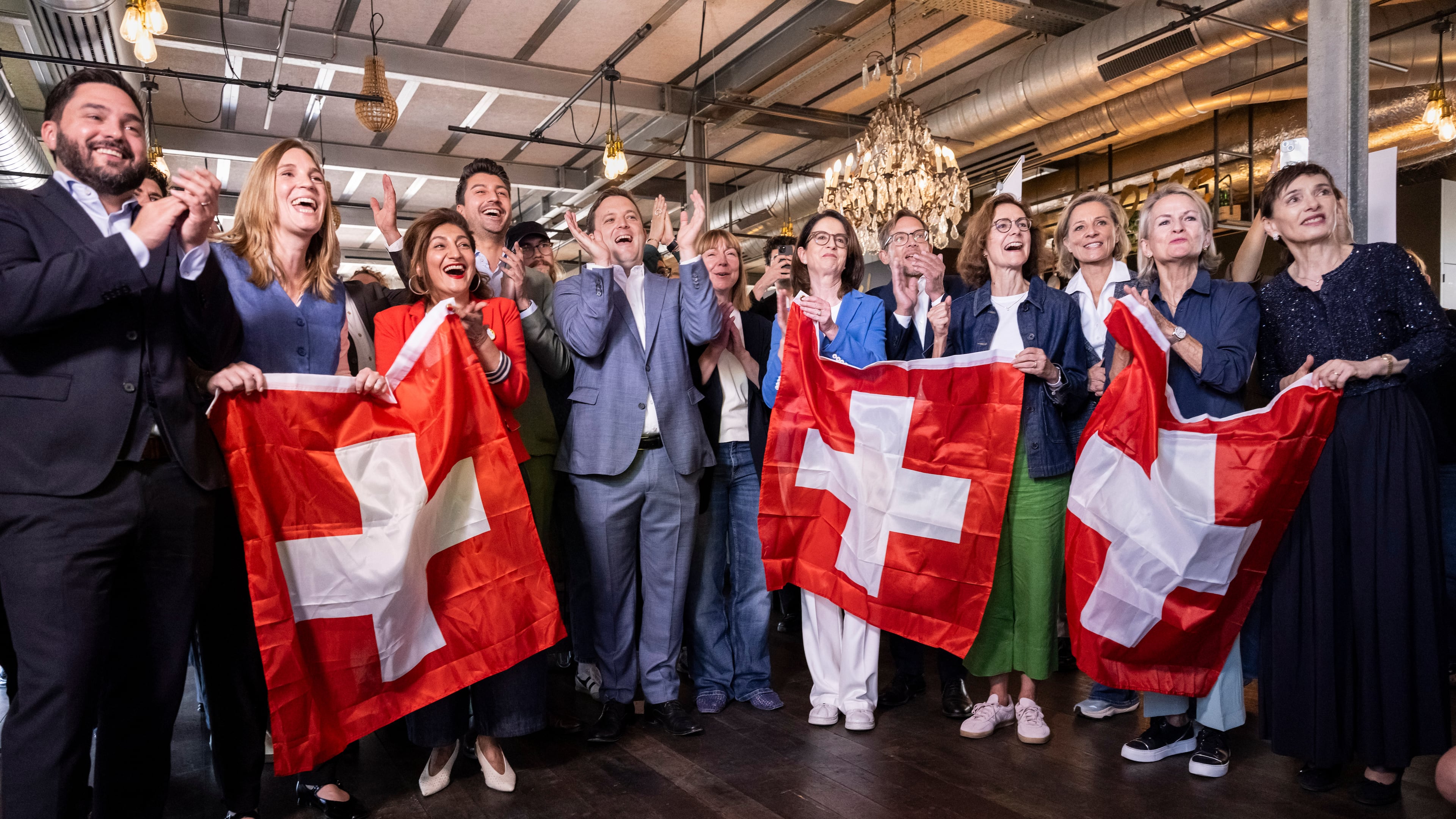 Co-President of the Swiss Social Democratic Party Cedric Wermuth, from left, along with National Council of Switzerland members Corina Gredig, Sibel Arslan, Fabian Molina, Heinz Theiler and Jon Pult, Council of States member Mathilde Crevoisier Crelier, Co-President of the FDP Susanne Vincenz-Stauffacher, National Councilor Heinz Theiler, Director of the Swiss Business Federation Monika Rühl, National Councilor Simone De Montmollin and Council of the States members Andrea Gmür and Marianne Binder-Keller gather at the campaign office for the committee opposing the neutrality initiative Sunday, Sept. 27, 2026, in Bern, Switzerland. (Alessandro della Valle/Keystone via AP)