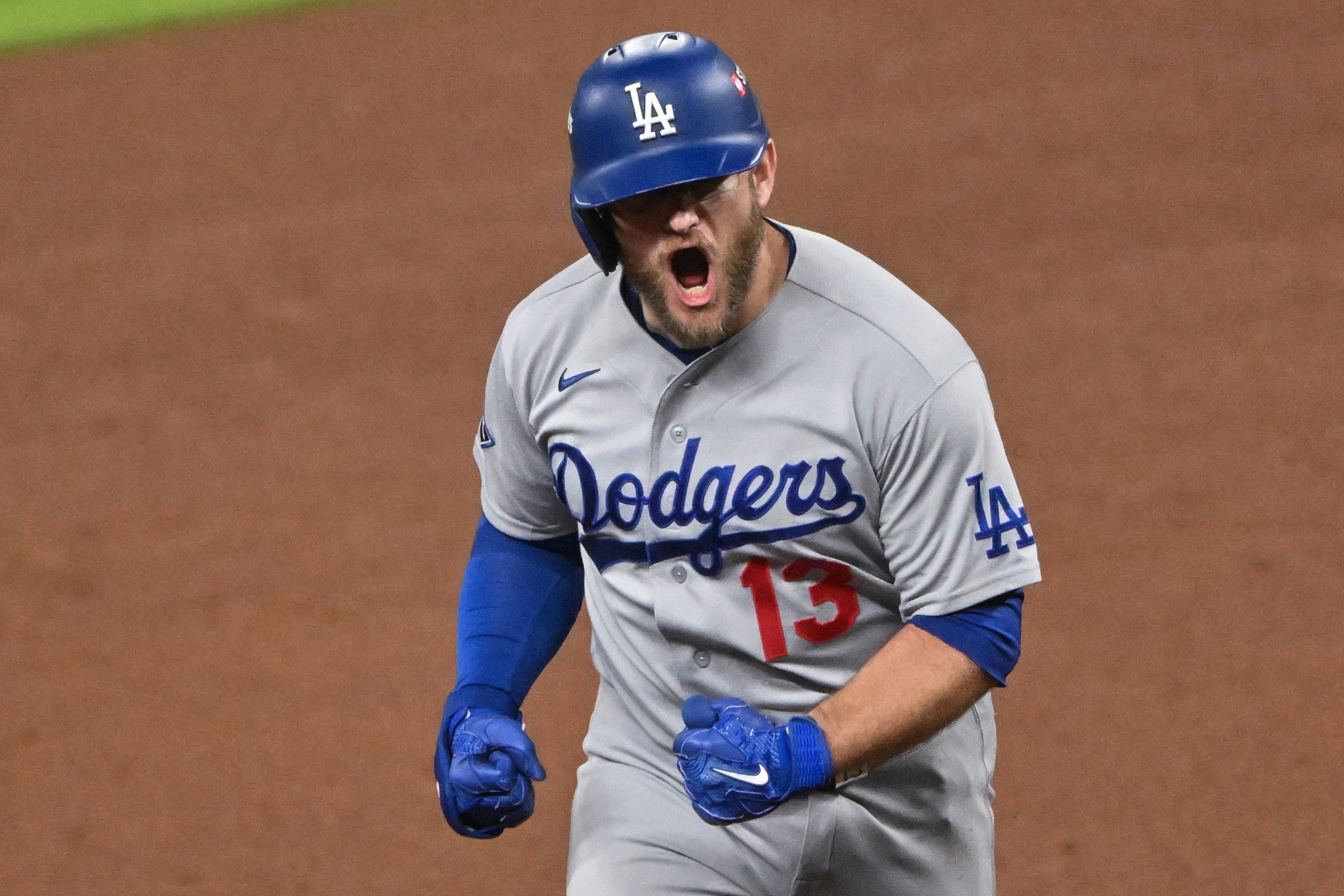 Los Angeles Dodgers' Max Muncy (13) reacts after hitting a solo home run against the Atlanta Braves during the ninth inning of Game 4 of the MLB National League Division Series between the Atlanta Braves and the Los Angeles Dodgers, Wednesday, Oct. 7, 2026, in Atlanta. (Hyosub Shin/AJC)