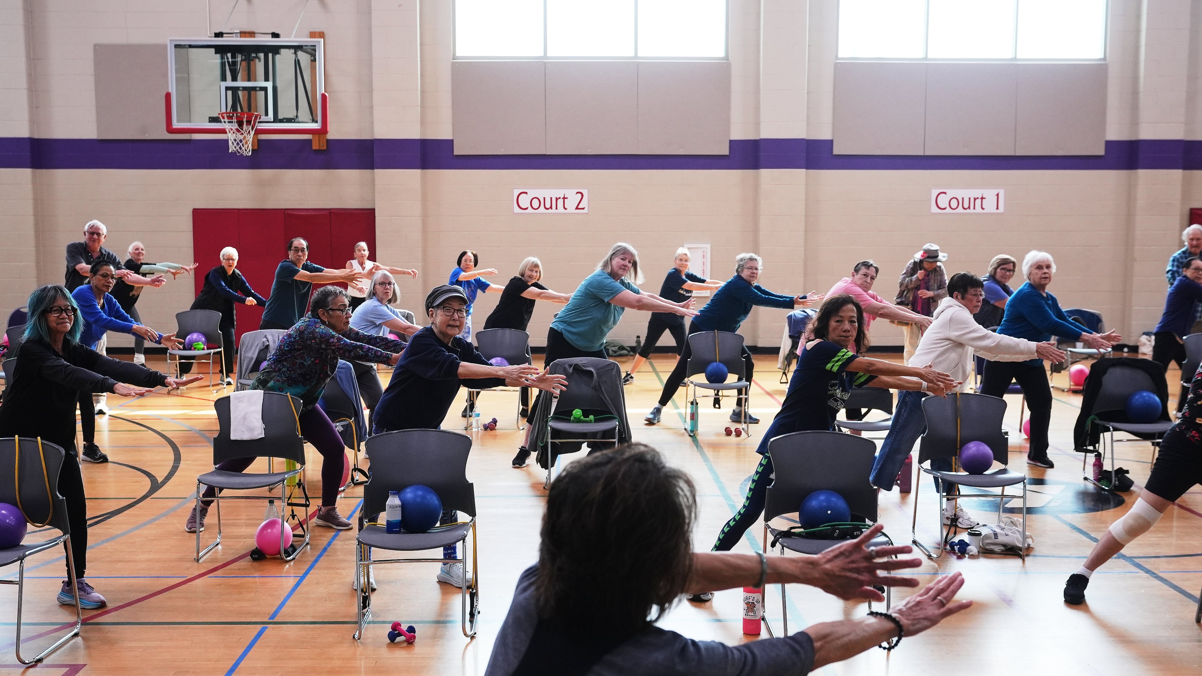Instructor Bengie Santos, 72, at front, leads an exercise class for older adults at the Dale Turner Family YMCA, April 30, 2026, in Shoreline, Wash. (AP Photo/Lindsey Wasson)