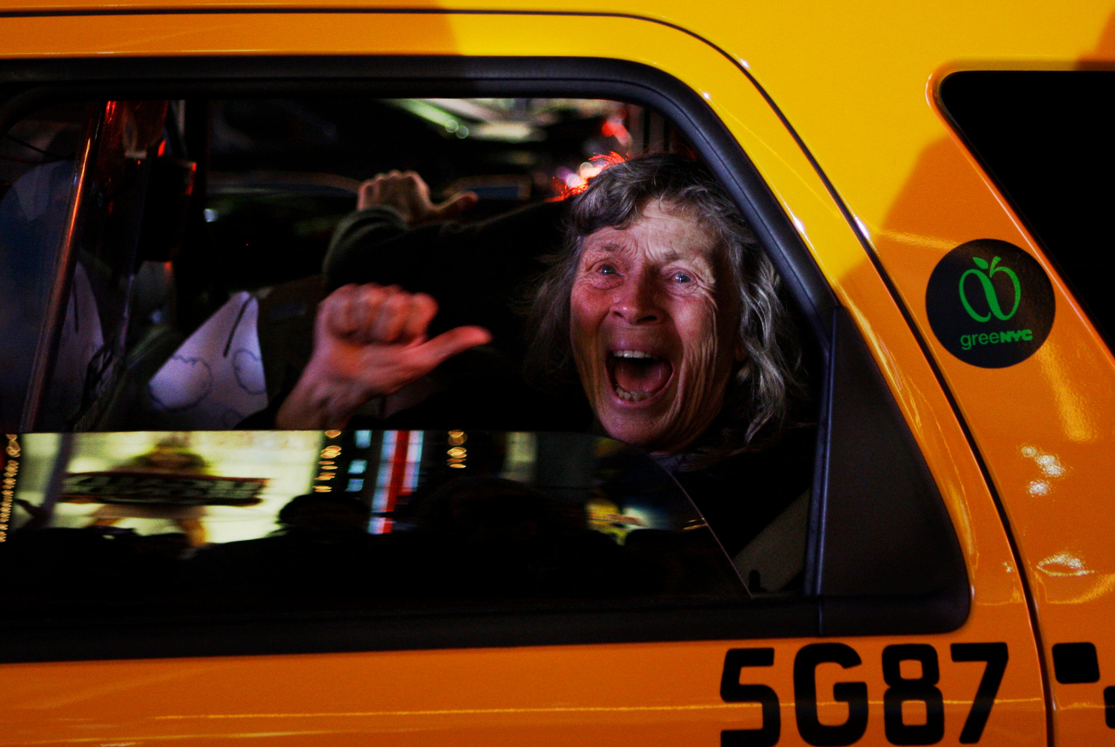 In this Tuesday, Nov. 4, 2008 file photo made by Associated Press photographer Anja Niedringhaus, a woman reacts while sitting in a New York taxi as different television networks call the presidential race for Barack Obama, in New York. Niedringhaus, 48, an internationally acclaimed German photographer, was killed and AP reporter Kathy Gannon was wounded on Friday, April 4, 2014 when an Afghan policeman opened fire while they were sitting in their car in eastern Afghanistan. (AP Photo/Anja Niedringhaus, File)