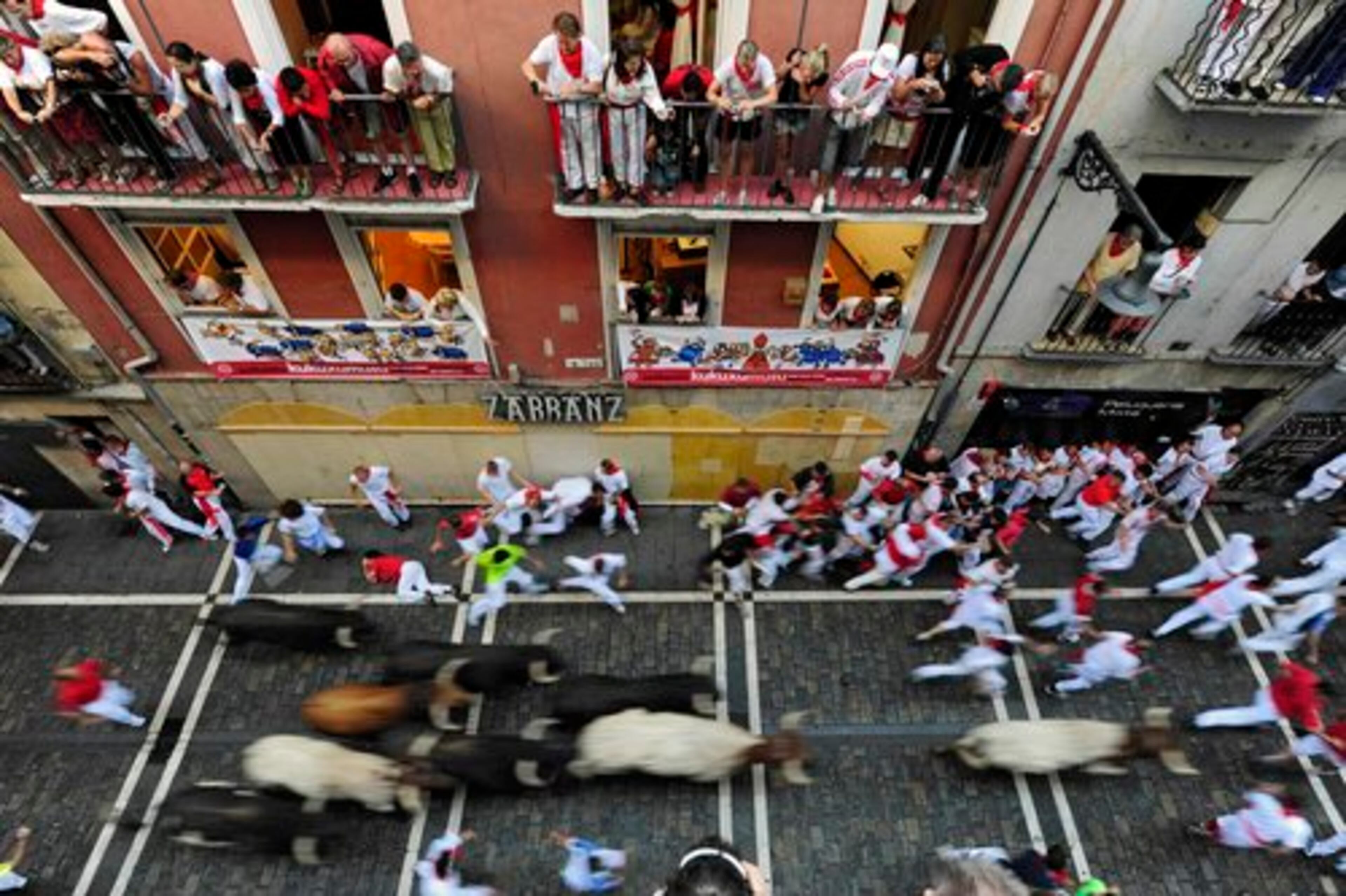 Thrill-seekers sprinted through Pamplona in a swift and relatively clean start to the running of the bulls. No one was gored on Tuesday, but four people were hospitalized with bumps, bruises or scrapes, Spanish Red Cross spokesman Jose Aldaba said.