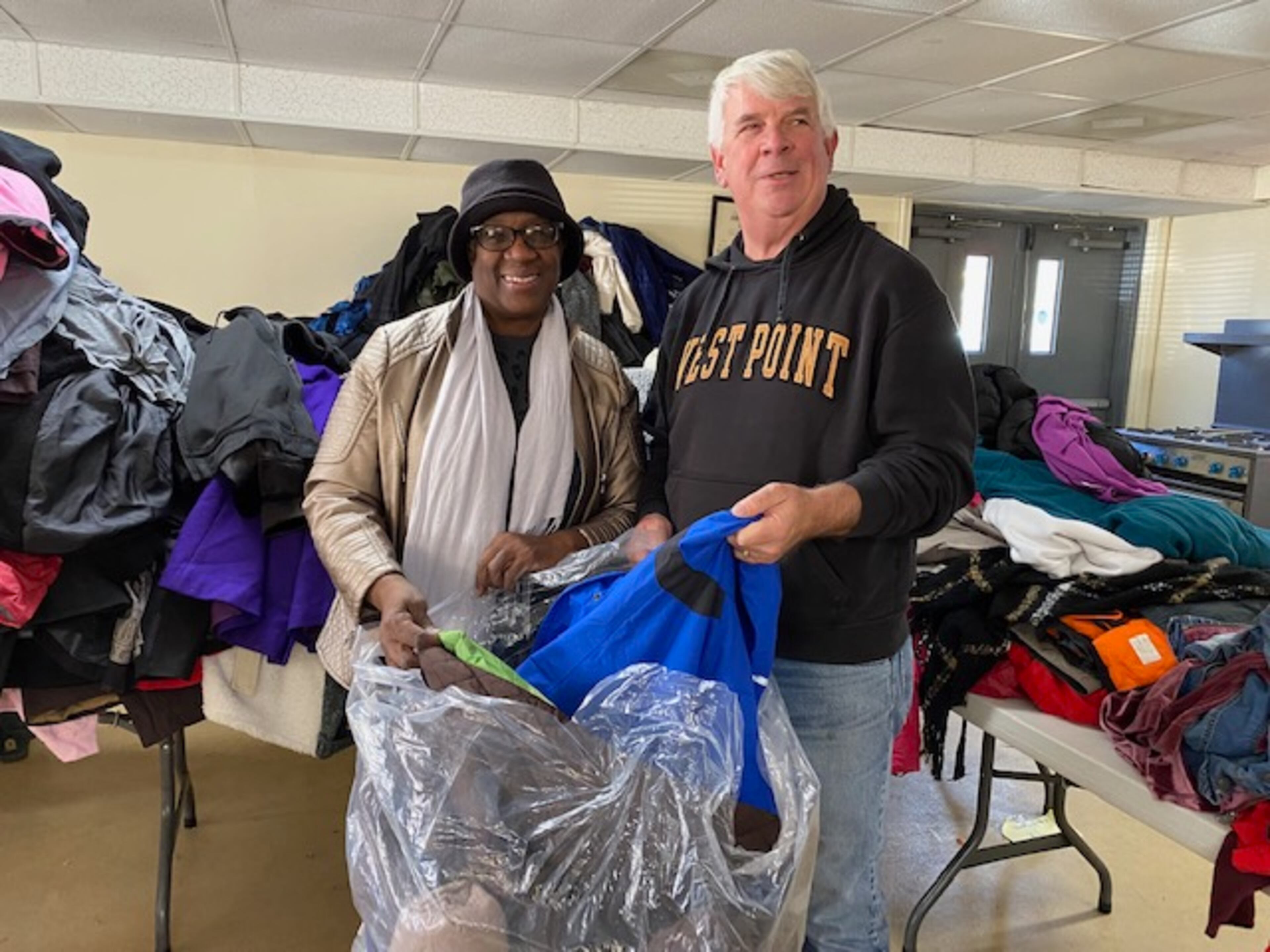 Jim Lindenmayer (left), founder of the Cherokee County Homeless Veterans Program, helps out with a coat drive.