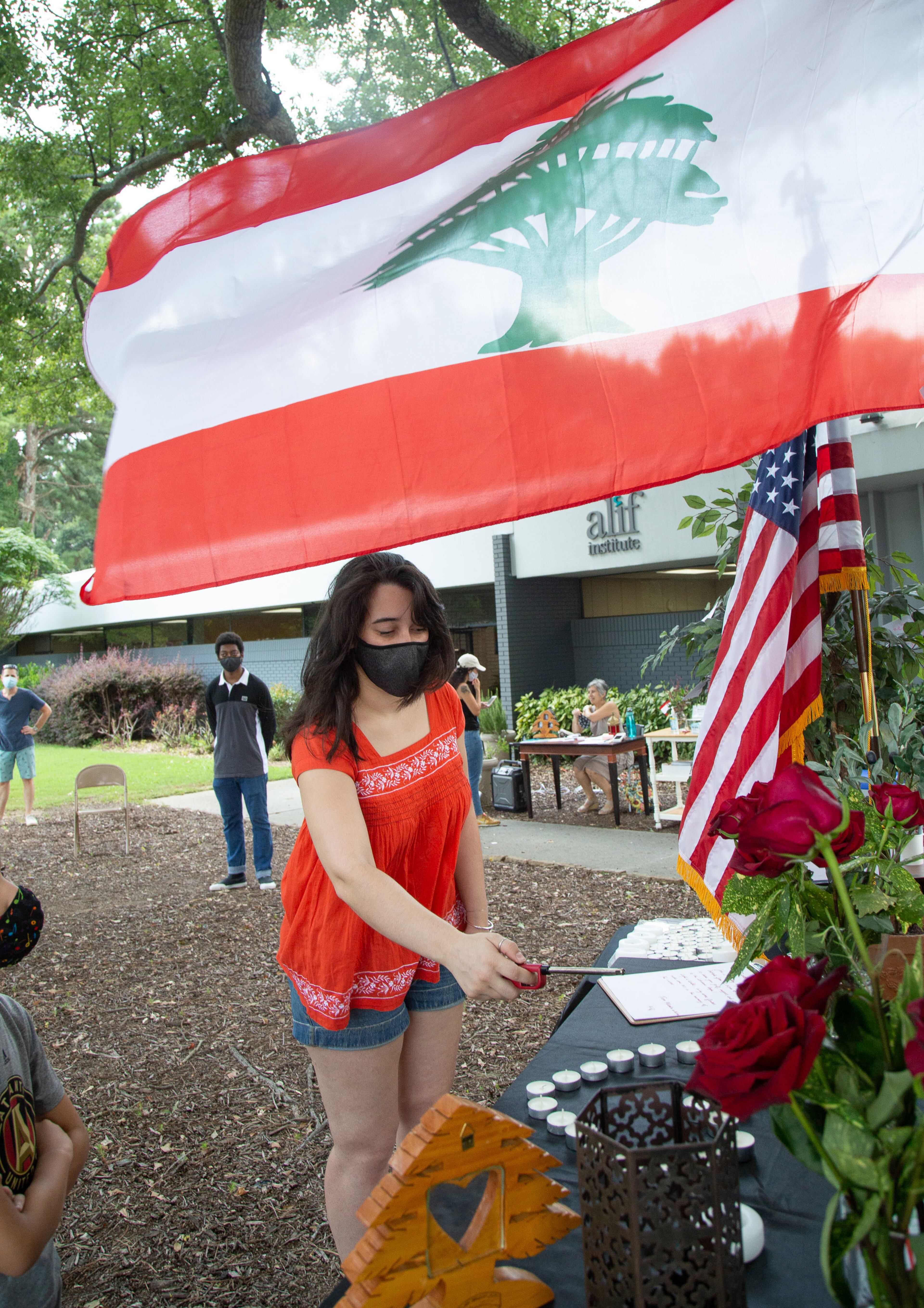 Iman Khoury lights candles during a vigil for the Lebanese people at the Alif Institute in Atlanta on Sunday, August 9, 2020. The event was to honor the victims of a deadly blast in Beirut, Lebanon, last week. STEVE SCHAEFER FOR THE ATLANTA JOURNAL-CONSTITUTION