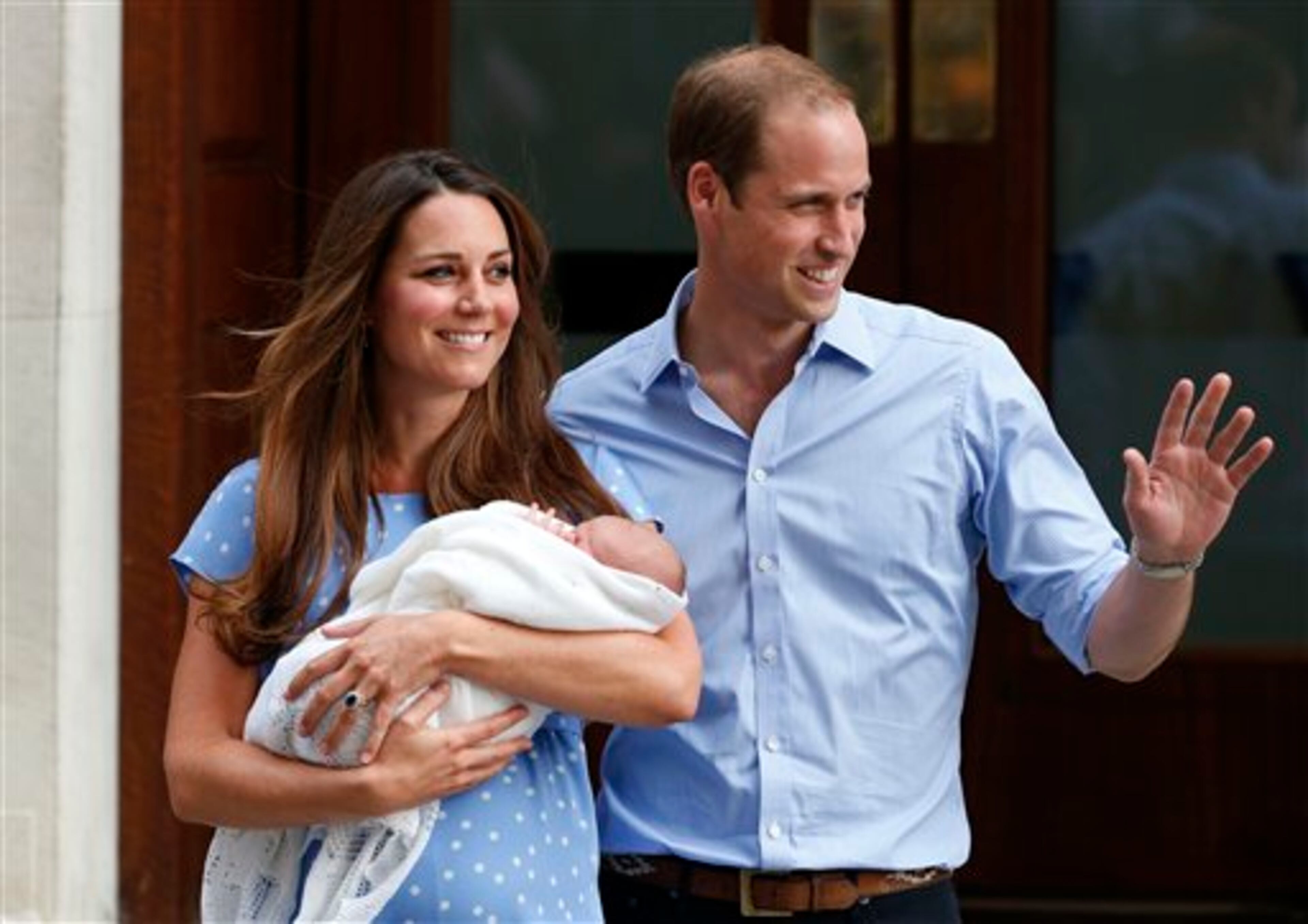 Britain's Prince William and Kate, Duchess of Cambridge hold the Prince of Cambridge, Tuesday July 23, 2013, as they pose for photographers outside St. Mary's Hospital exclusive Lindo Wing in London where the Duchess gave birth on Monday July 22. The Royal couple are expected to head to London�s Kensington Palace from the hospital with their newly born son, the third in line to the British throne. (AP Photo/Lefteris Pitarakis)