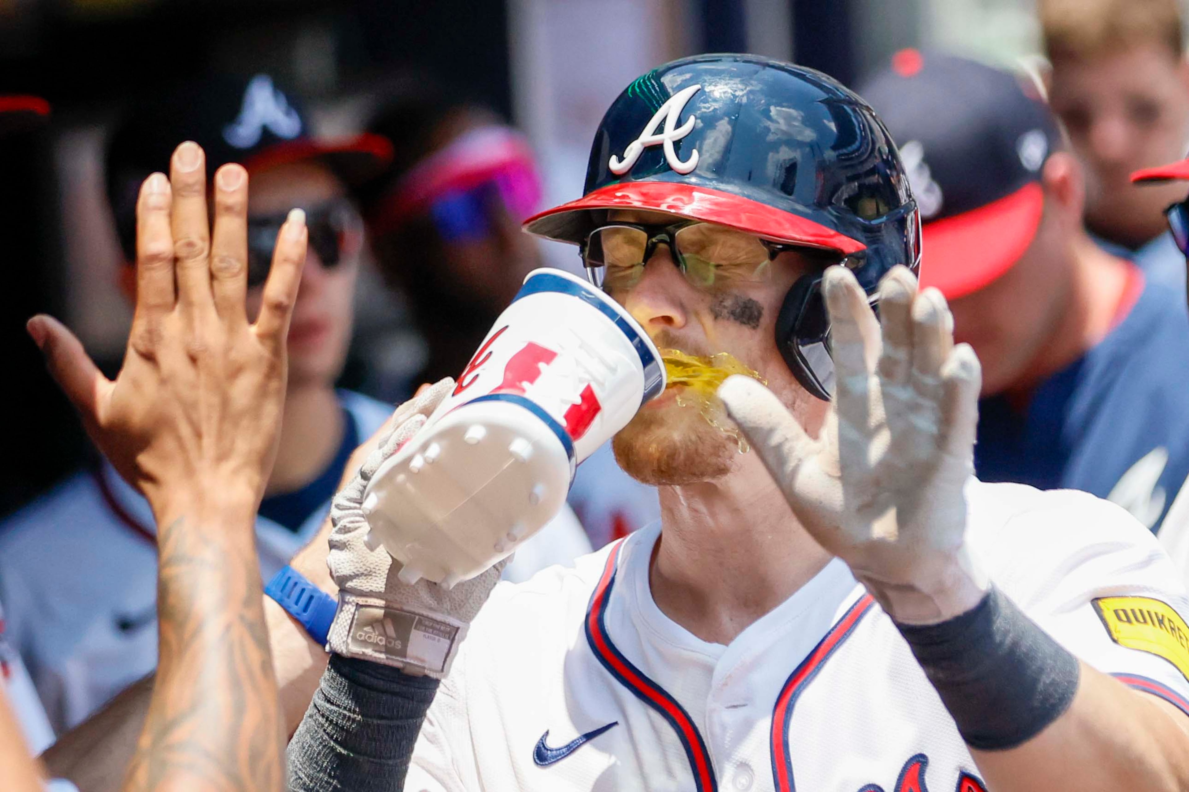 \Atlanta Braves catcher Sean Murphy (12) takes a dring as he celebrates with teammates at the dugout after his solo home run home run durring the ninth inning at Truist Park on Sunday, July 6, 2025, in Atlanta.
(Miguel Martinez/ AJC)