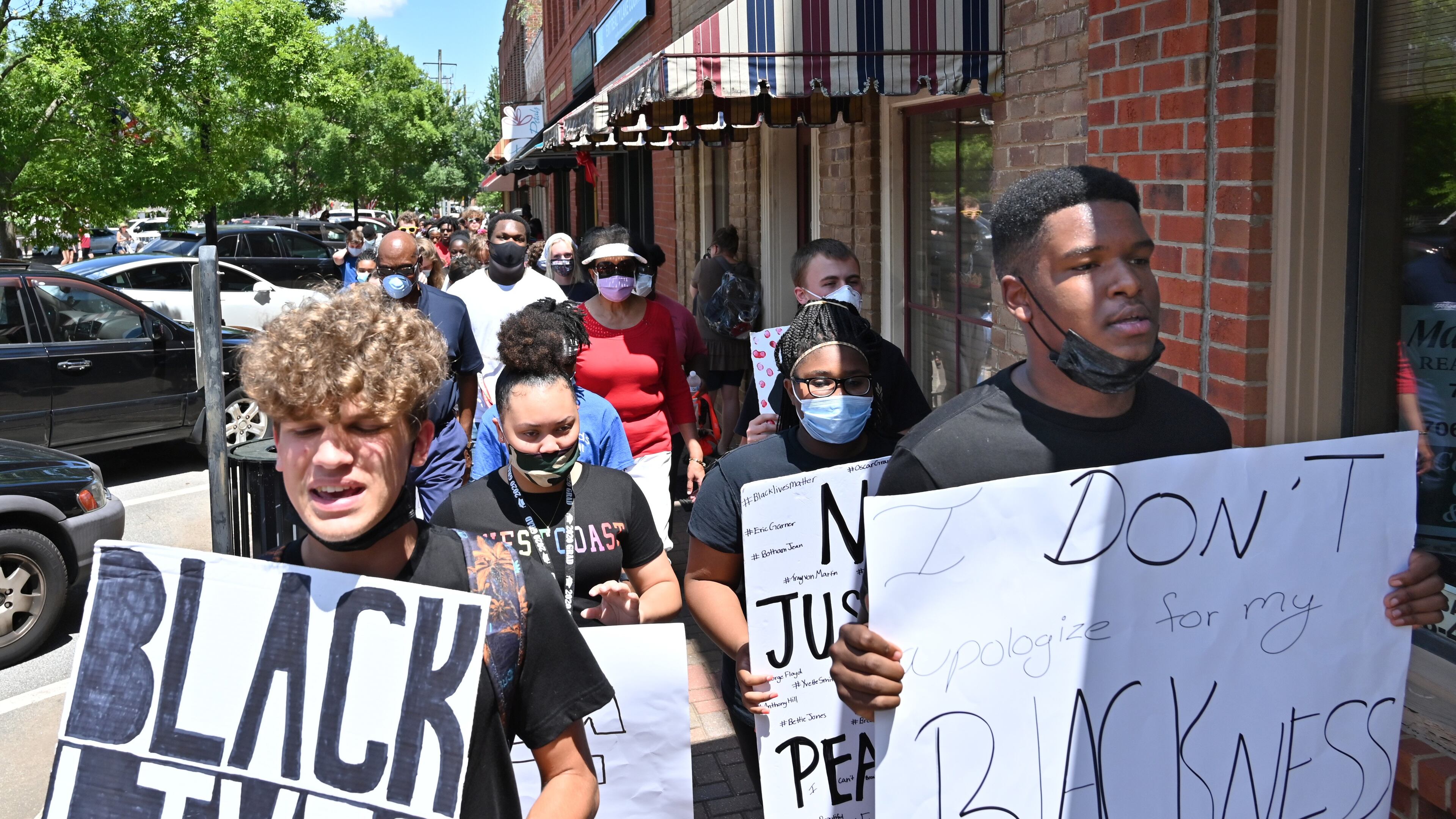 John Kirbymurdoch. left, and Alex Williams, both 16 and students at Morgan County High School, lead a peaceful, youth-led march in downtown Madison in June. (Hyosub Shin / Hyosub.Shin@ajc.com)
