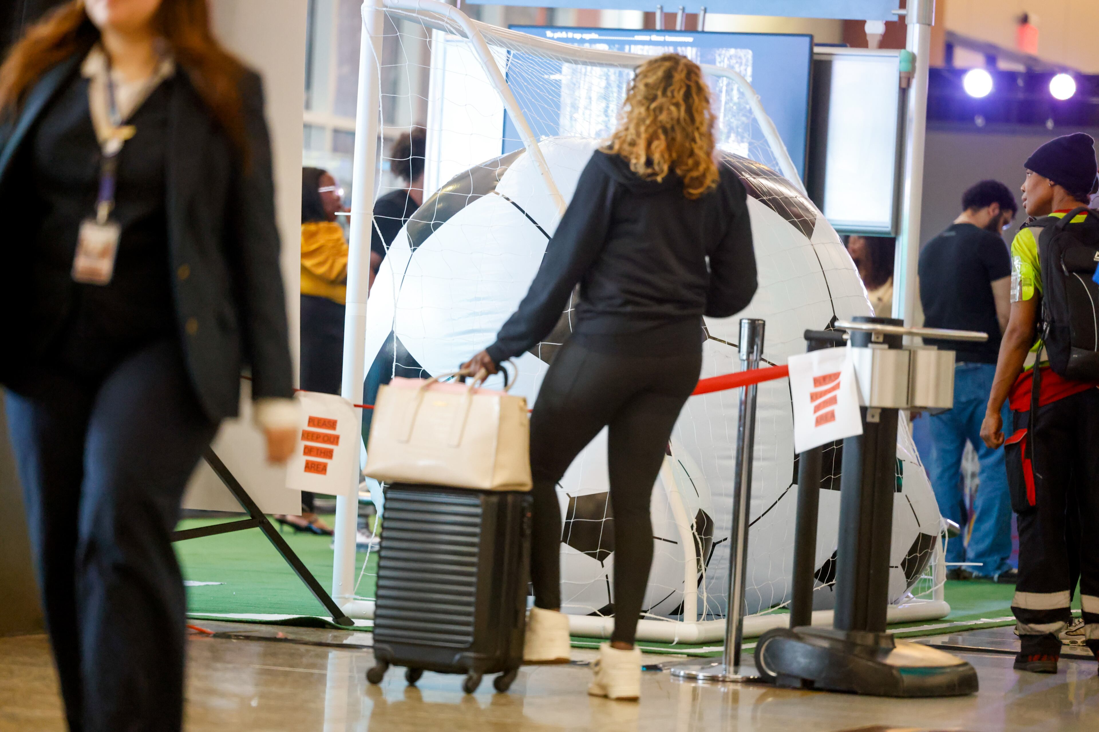 A traveler looks at the "From Gates to Goals" exhibit celebrating the upcoming FIFA World Cup at Hartsfield-Jackson Atlanta International Airport's international terminal in Atlanta on May 27, 2026. (Arvin Temkar/AJC)