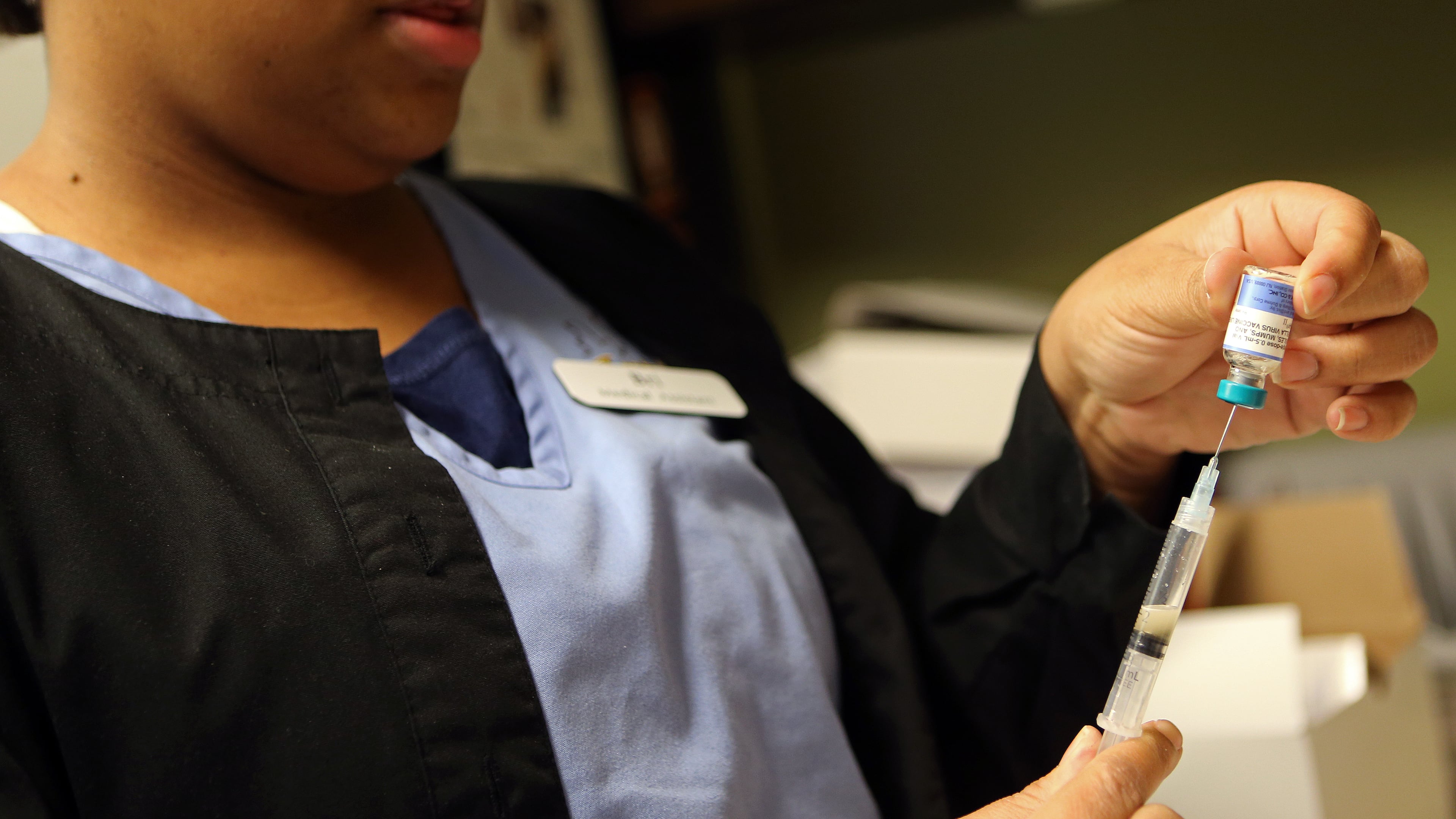 Brianna Gilyard, lead medical assistant at Intown Pediatrics & Adolescent Medicine, prepares a measles, mumps and rubella vaccine.