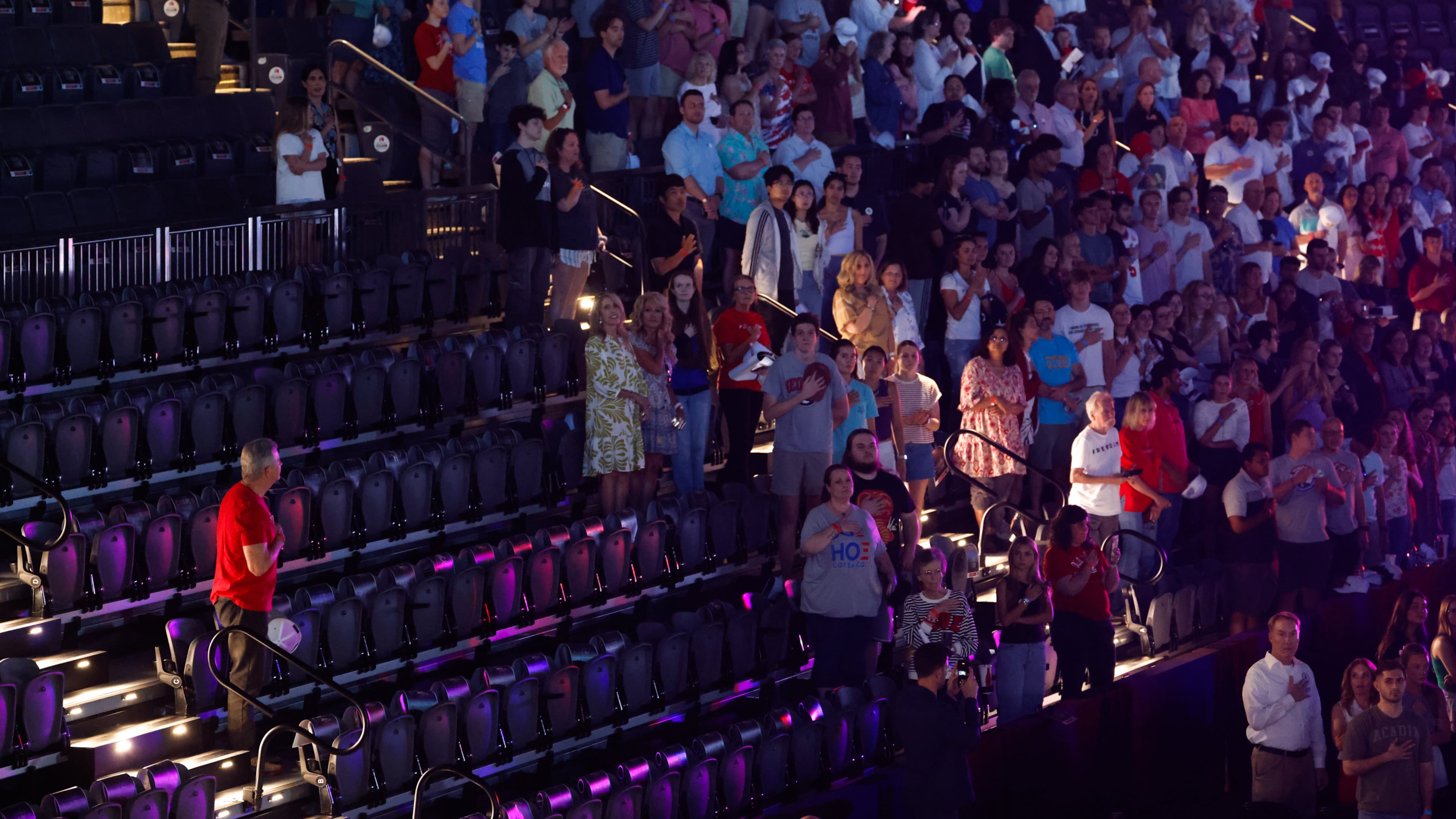 Attendees stand for the national anthem before a Turning Point USA event near the University of Georgia on Tuesday, April 14, 2026. (Arvin Temkar/AJC)