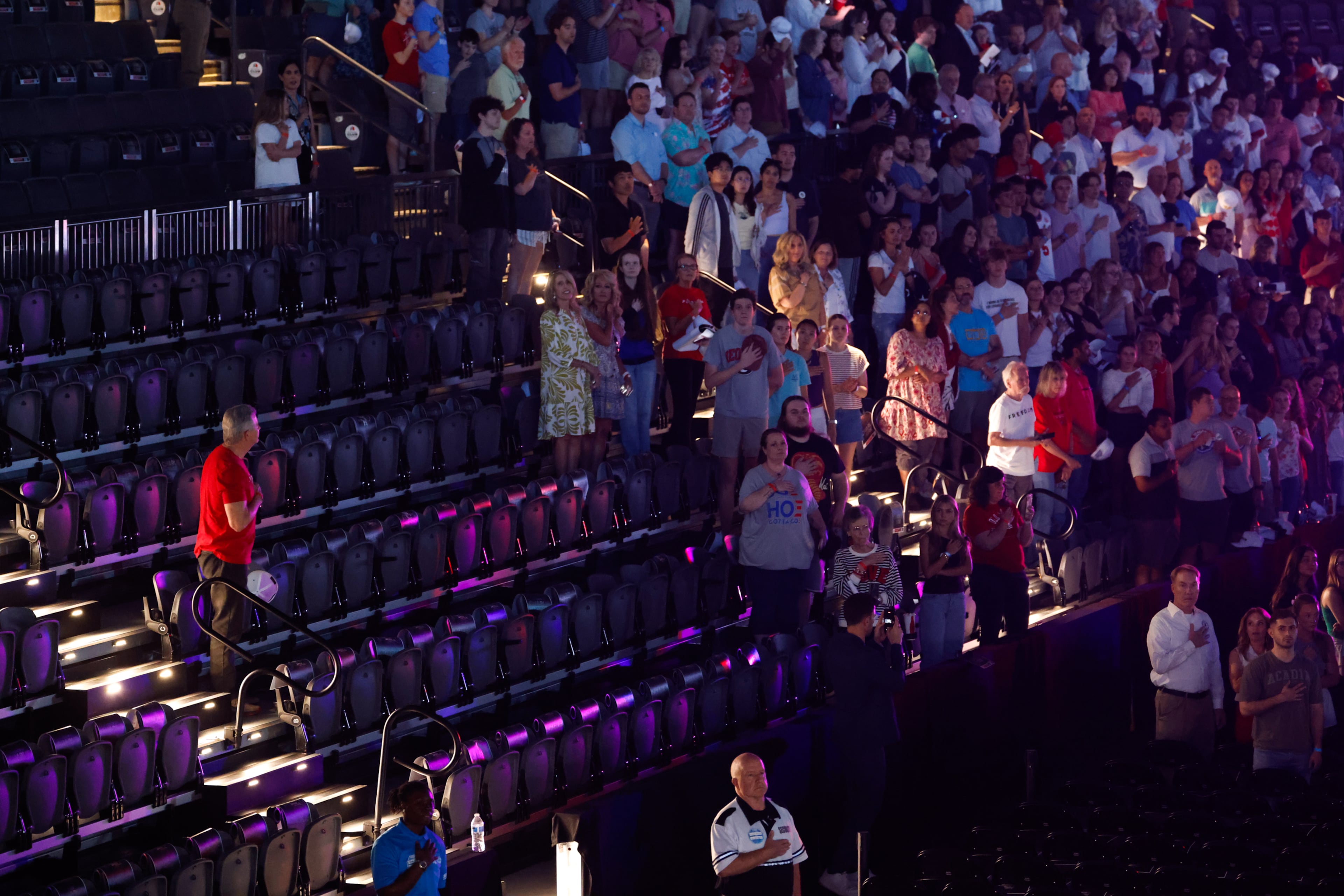 Attendees stand for the national anthem before a Turning Point USA event near the University of Georgia on Tuesday, April 14, 2026. (Arvin Temkar/AJC)