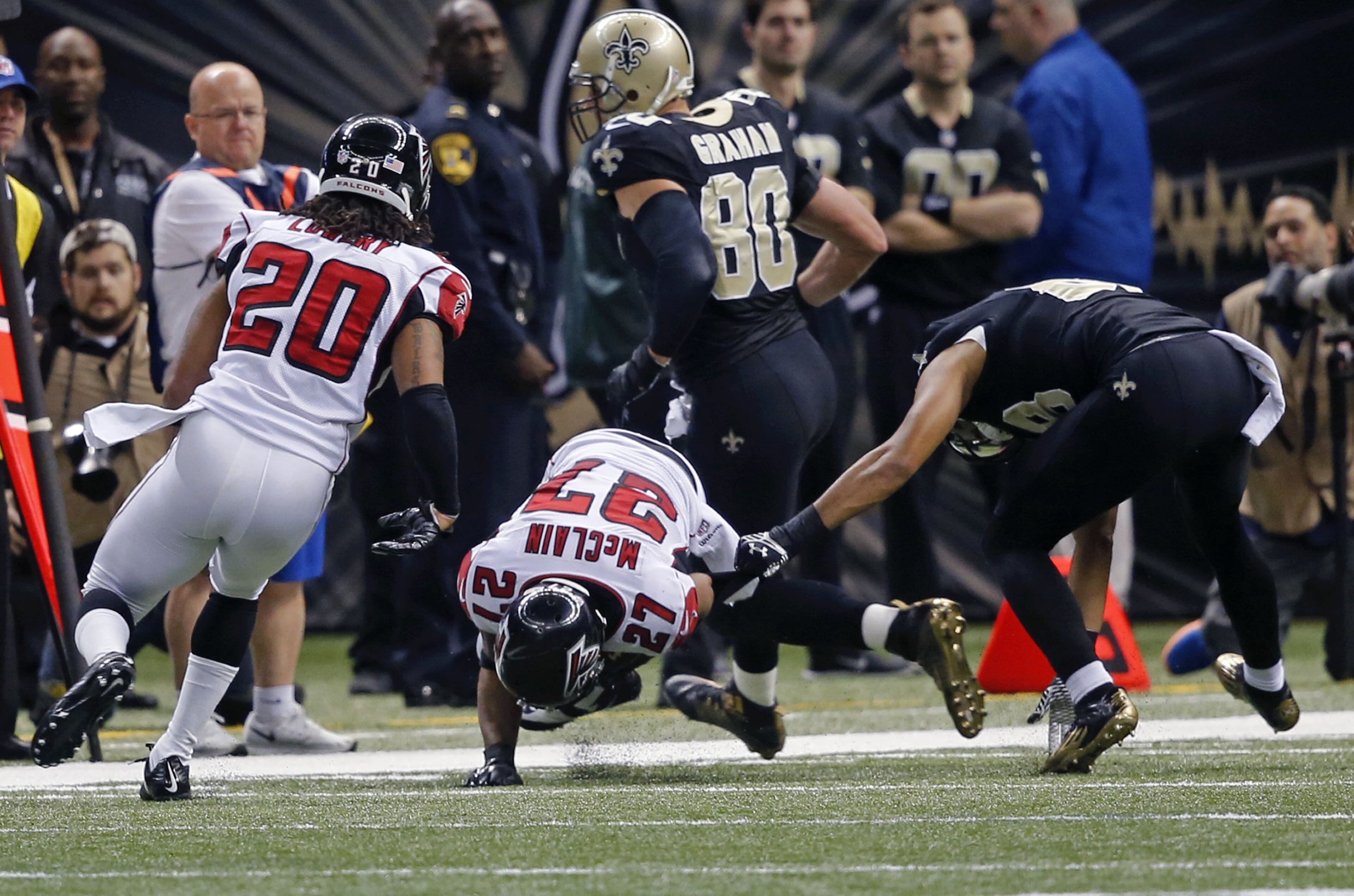 Atlanta Falcons cornerback Robert McClain (27) intercepts a pass intended for New Orleans Saints wide receiver Nick Toon, right, in the second half of an NFL football game in New Orleans, Sunday, Dec. 21, 2014. (AP Photo/Bill Haber)