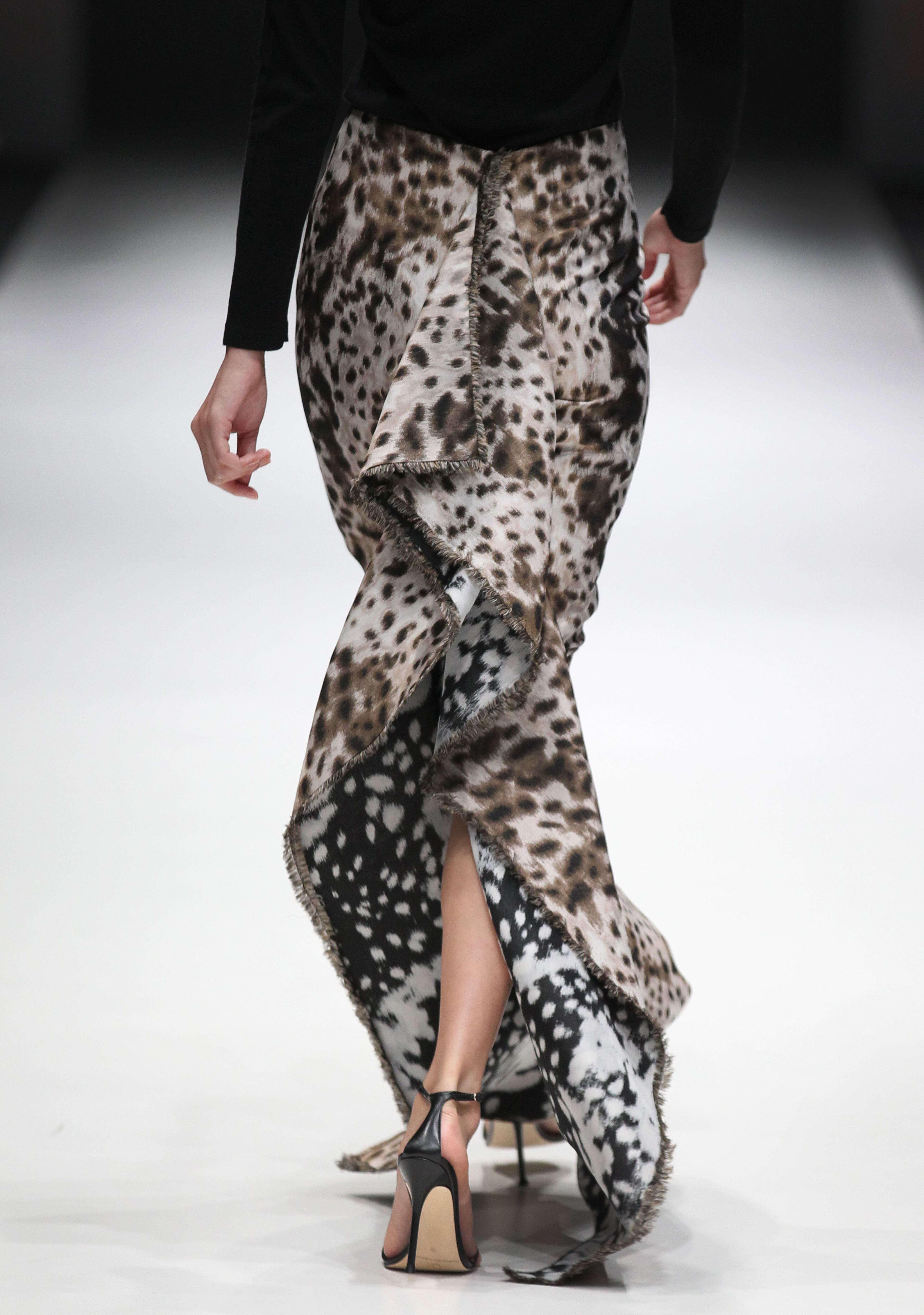 A model showcases an outfit by New York based designer Carolina Herrera for 'The House of Herrera' Fall 2013 collection, in Singapore, Wednesday, May 15, 2013, during the annual Fashion Festival held in the city-state. (AP Photo/Wong Maye-E)