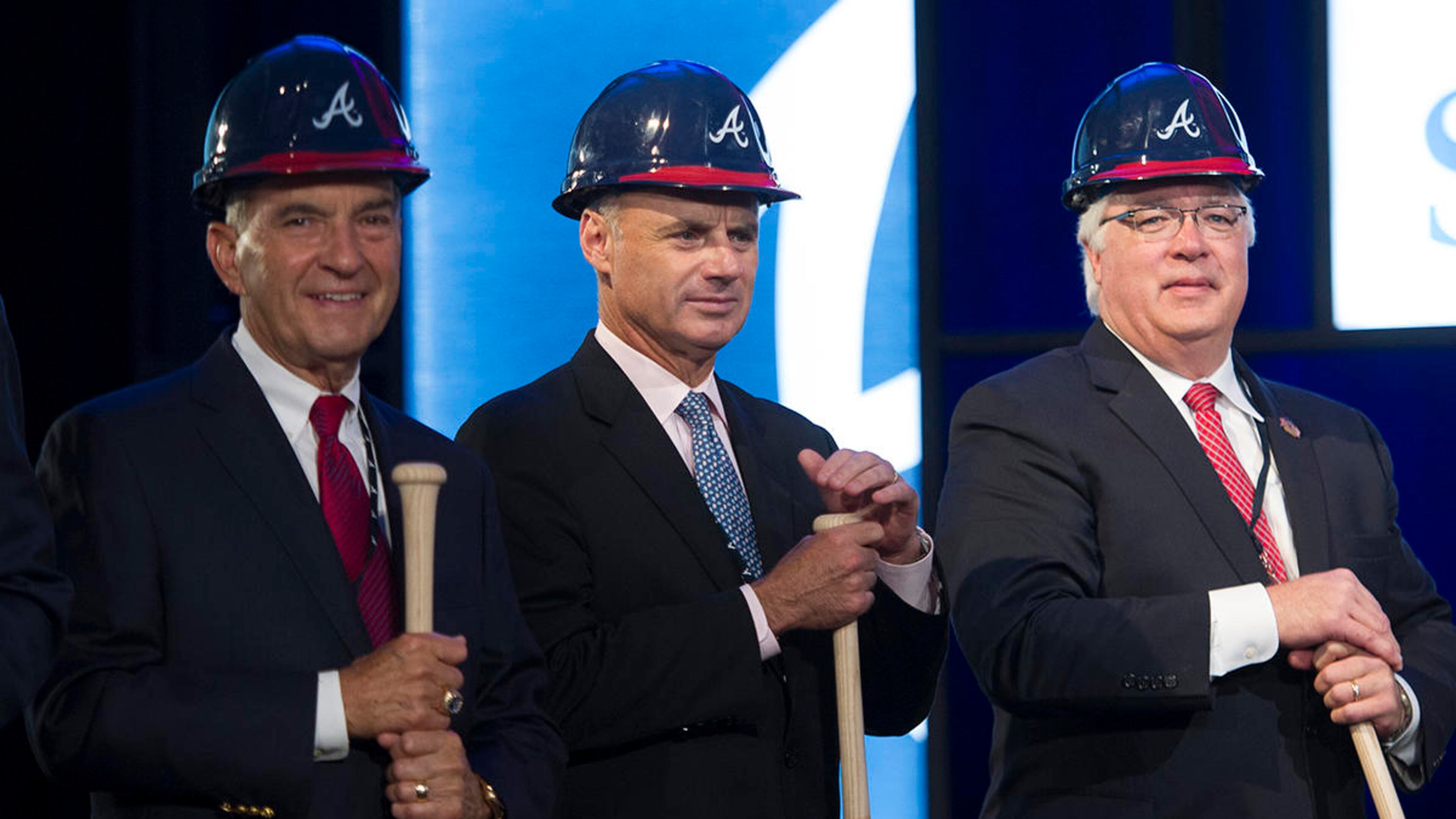 Baseball Commissioner Elect Rob Manfred, center, is seen with Atlanta Braves President John Schuerholz, left, and Cobb County Chairman Tim Lee, right, during a ground breaking ceremony for the Atlanta Braves new stadium which will be called SunTrust Park, Tuesday, Sept. 16, 2014, in Atlanta. The Braves will be moving from Turner Field in Fulton County to the new stadium being built in Cobb County in 2017. (AP Photo/John Amis)