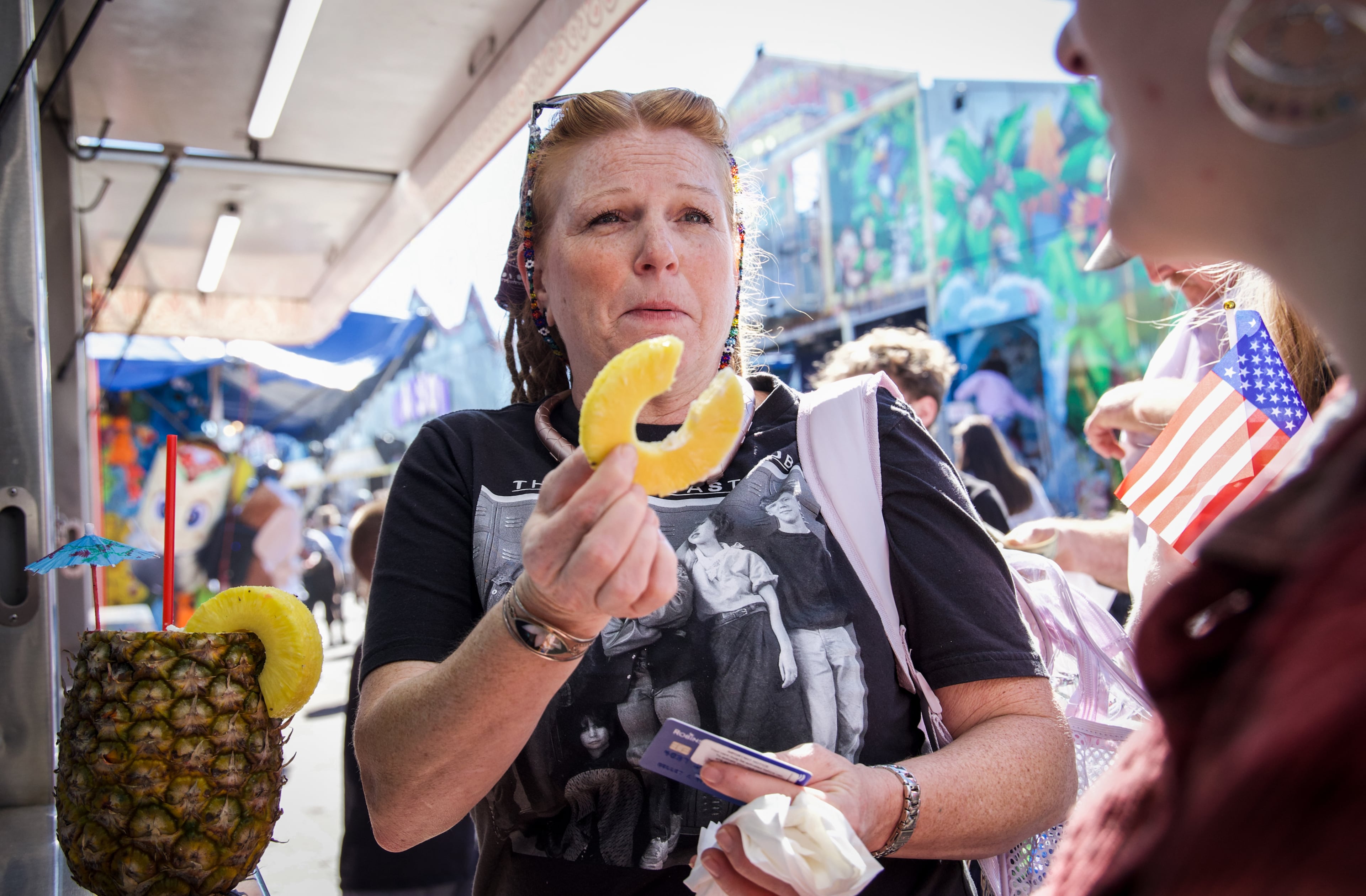 Carol Robinson, from Macon, shares the pineapple from her pineapple piña colada with her daughter Kelley Robinson at the Georgia National Fair in Perry, Georgia, on Oct. 17, 2026. Carol Robinson comes every year to the fair with her kids Kelley and Daniel Robinson. (Emily Laycock/UGA Photojournalism Workshop)