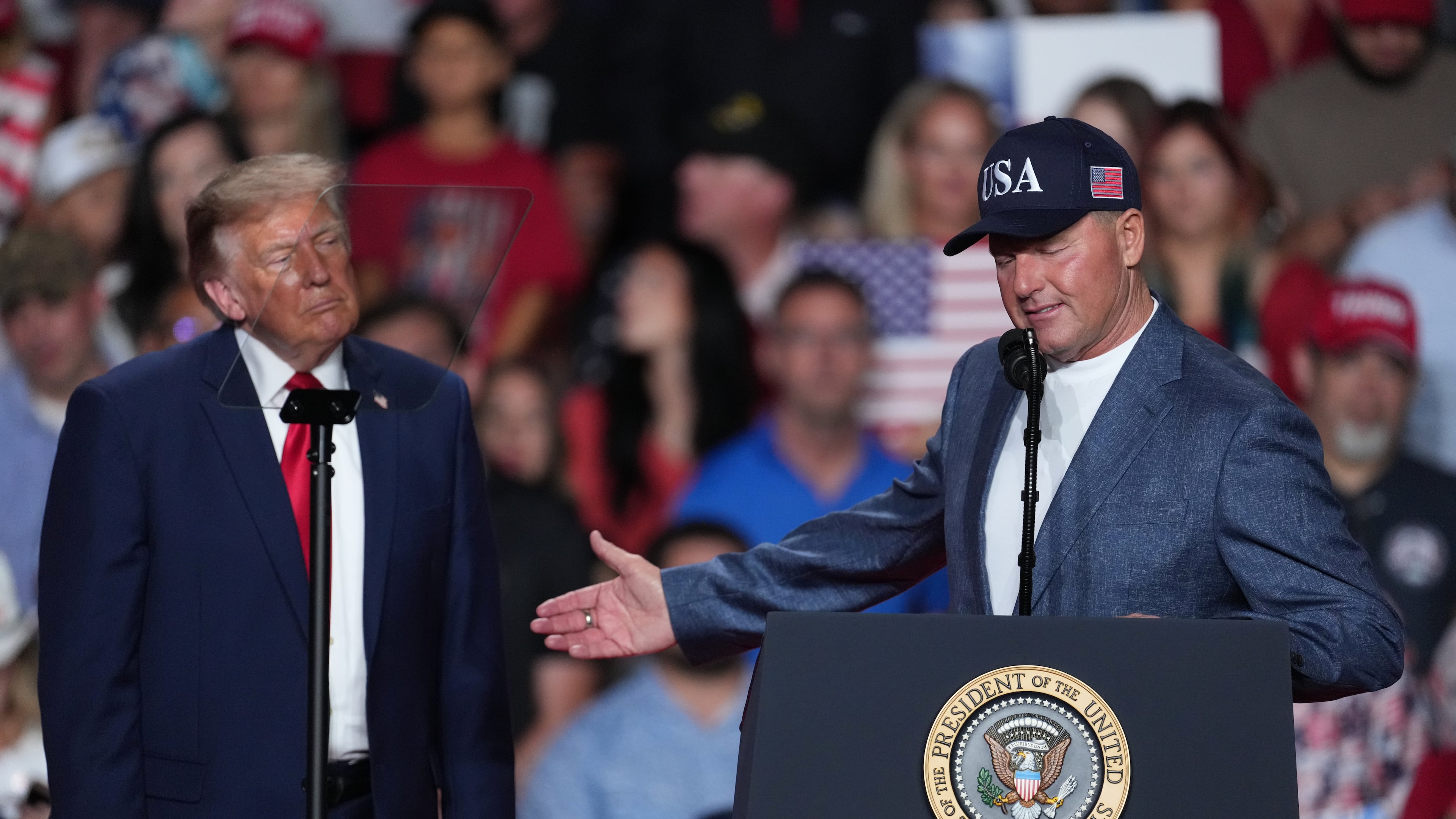 President Donald Trump listens as Roger Clemens speaks at a campaign rally at the Freeman Coliseum in San Antonio, Wednesday, Oct. 7, 2026. (AP Photo/Eric Gay)