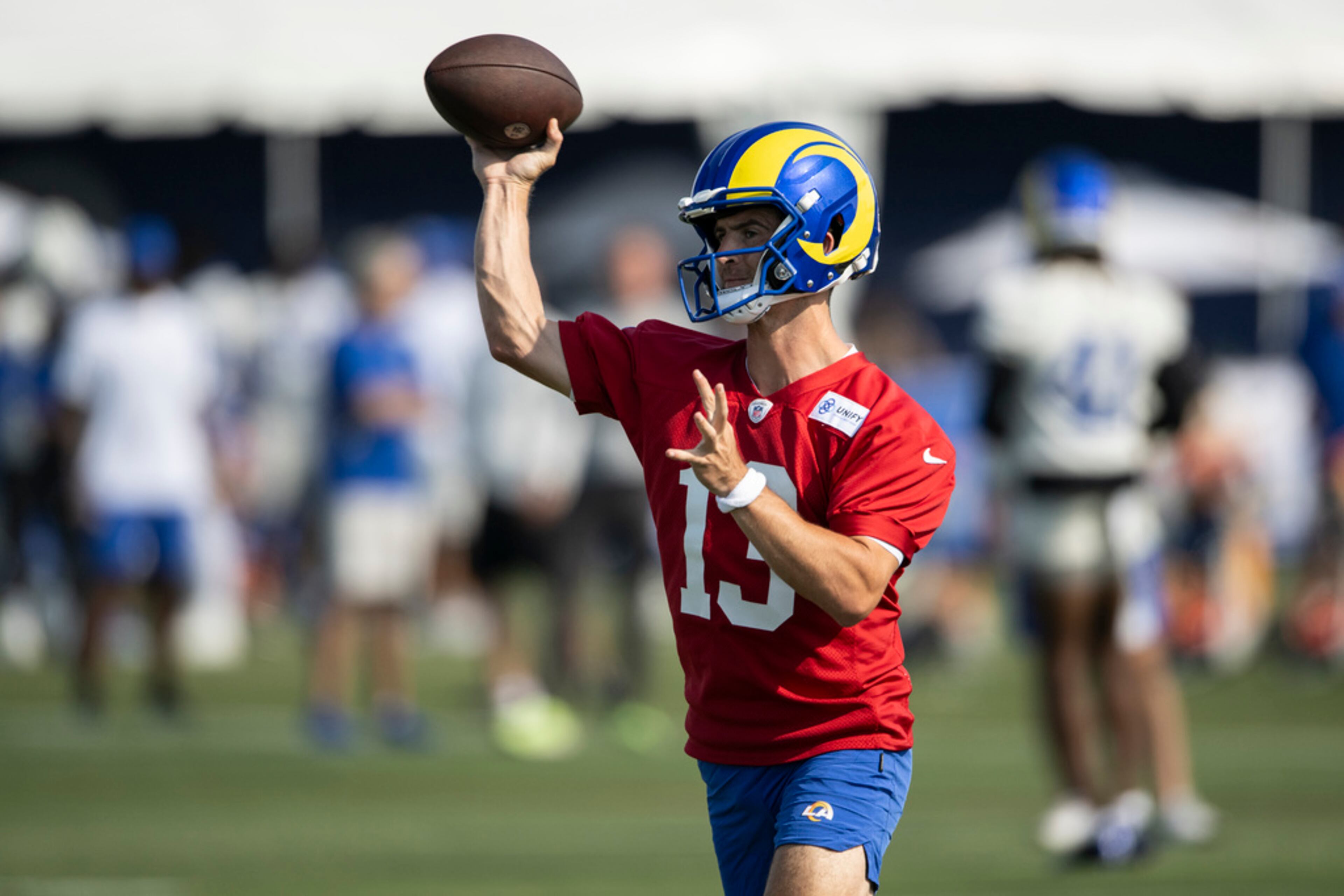 Los Angeles Rams quarterback Stetson Bennett (13) throws a pass at the NFL football team's training camp, Saturday, July 29, 2023, in Irvine, Calif. (AP Photo/Kyusung Gong)