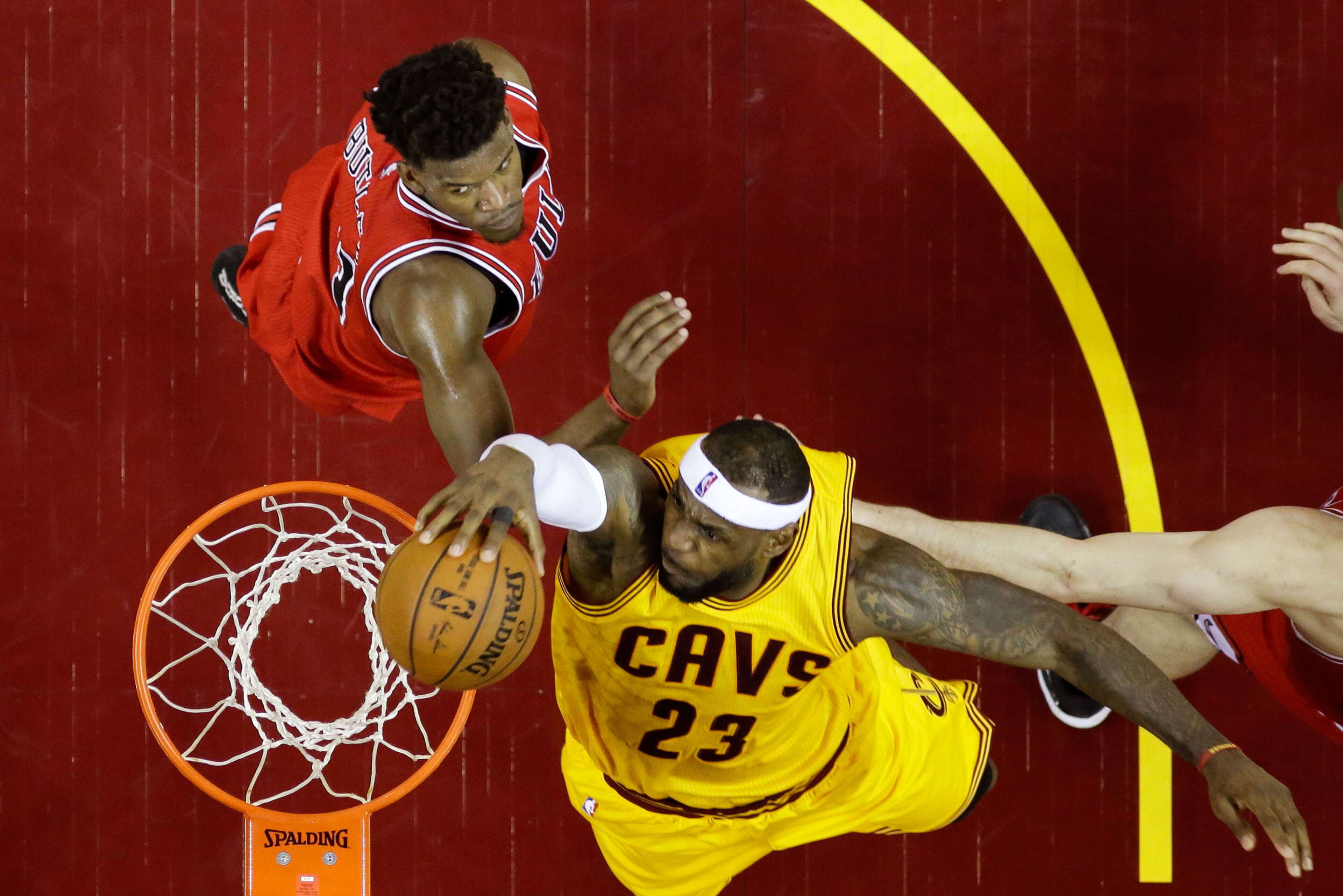 Cleveland Cavaliers forward LeBron James (23) dunks the ball against Chicago Bulls guard Jimmy Butler (21) during the first half of Game 2 in a second-round NBA basketball playoff series Wednesday, May 6, 2015, in Cleveland. (AP Photo/Tony Dejak)