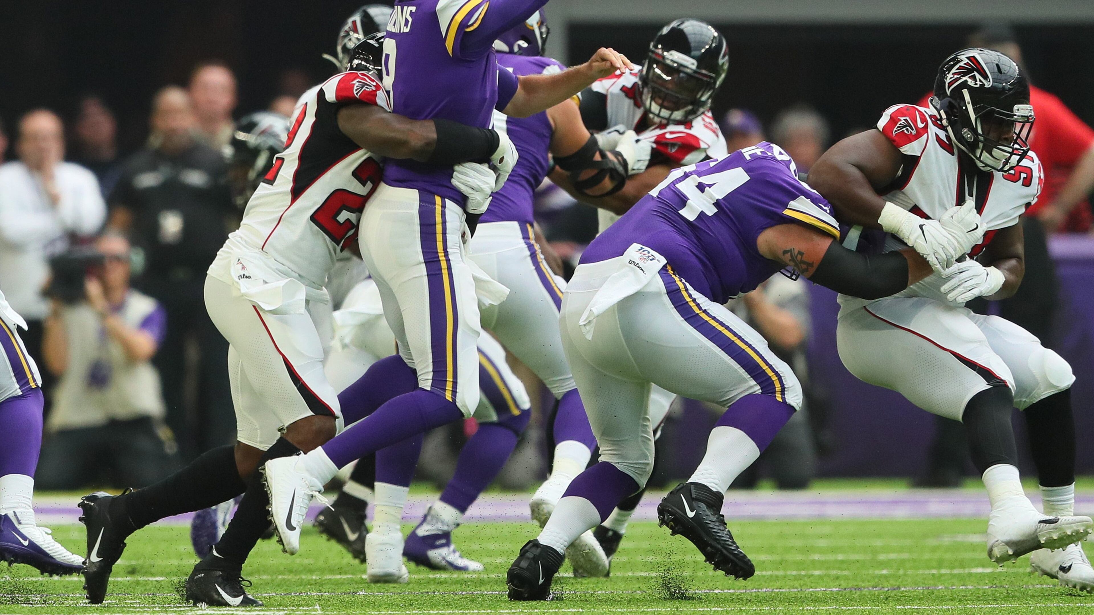 Kirk Cousins of the Minnesota Vikings takes a hit from Keanu Neal of the Atlanta Falcons in the first quarter at U.S. Bank Stadium on September 8, 2019 in Minneapolis, Minnesota. The play was ruled an incomplete pass. (Photo by Adam Bettcher/Getty Images)