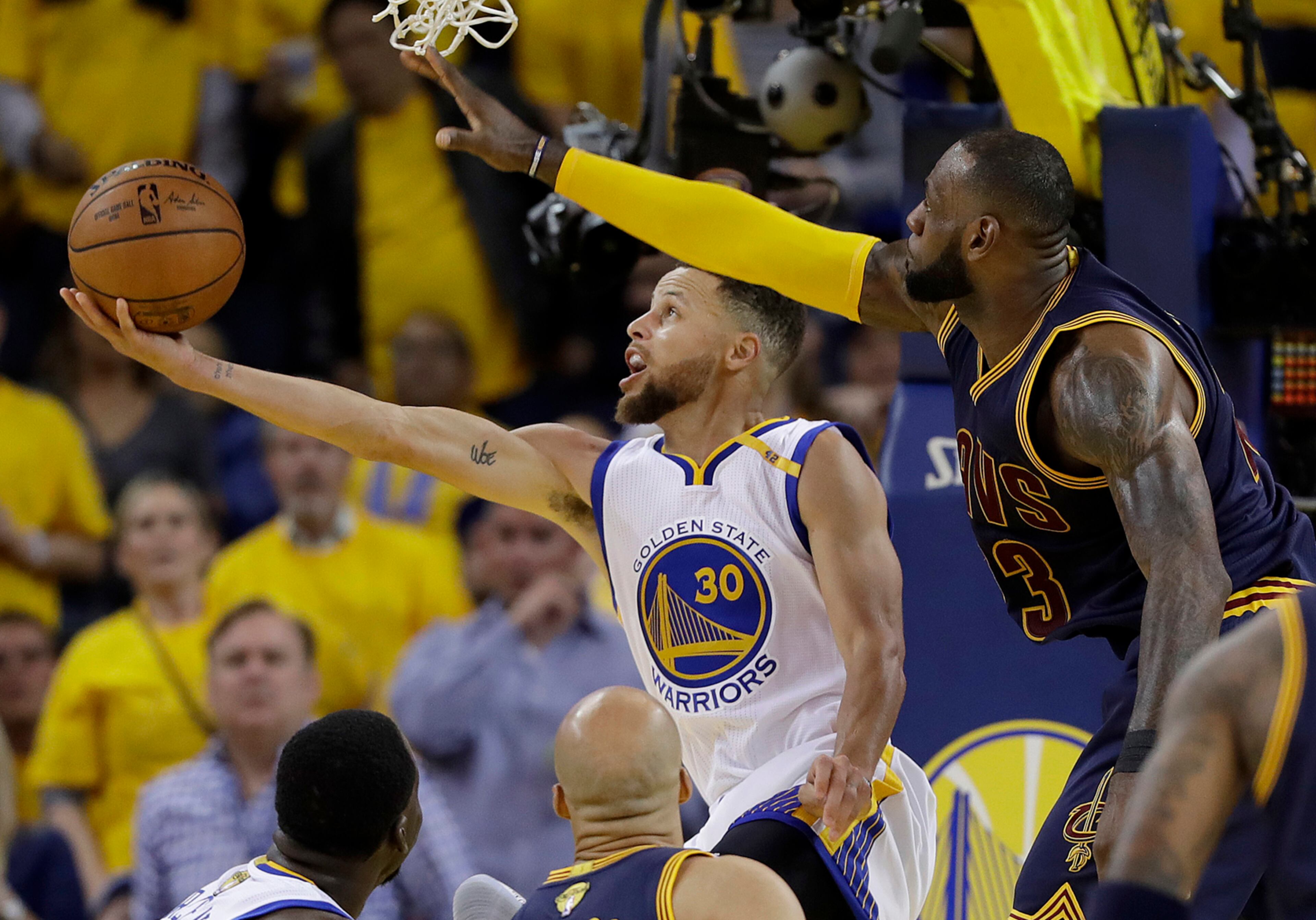 Golden State Warriors guard Stephen Curry (30) shoots against Cleveland Cavaliers forward LeBron James during the second half of Game 1 of basketball's NBA Finals in Oakland, Calif., Thursday, June 1, 2017. (AP Photo/Marcio Jose Sanchez)