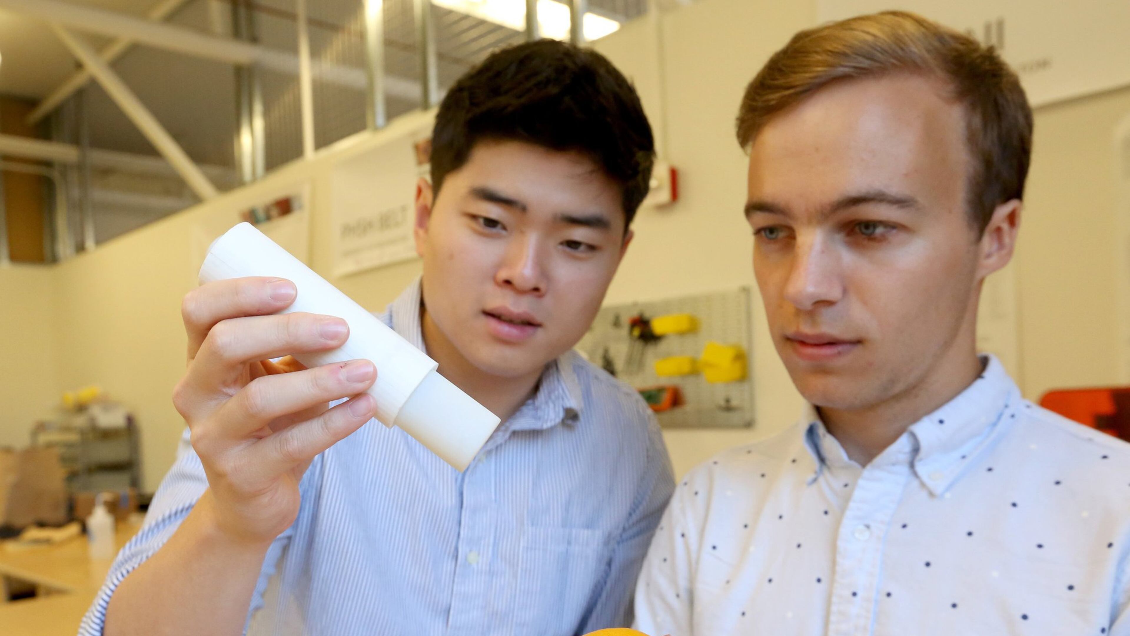 University of Washington engineering students Ha Seung Chung, left, and Shawn Swanson demonstrate their inexpensive replacement for the EpiPen. (Greg Gilbert/Seattle Times/TNS)