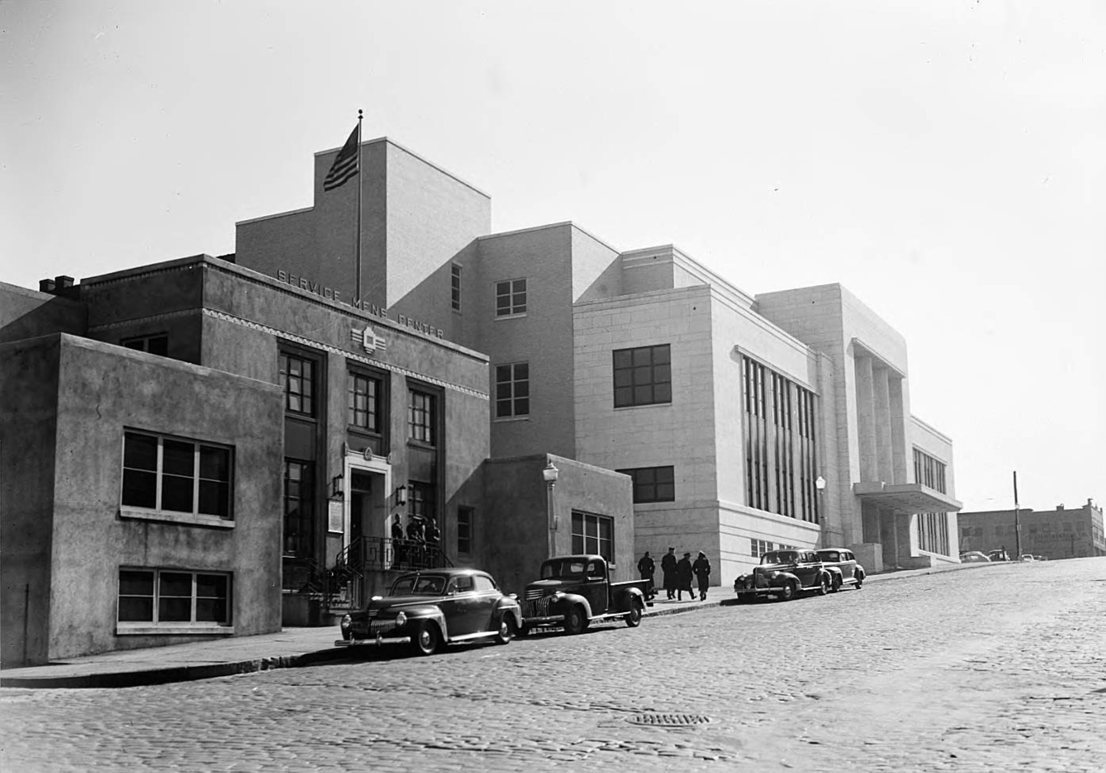 Atlanta Municipal Auditorium (right) and front left is the Service Men's Center, a U.S.O. facility. The auditorium is now Georgia State University's Dahlberg Hall at Courtland and Gilmer. LBGPF3-047a, Lane Brothers Commercial Photographers Photographic Collection, 1920-1976. Photographic Collection, Special Collections and Archives, Georgia State University Library.