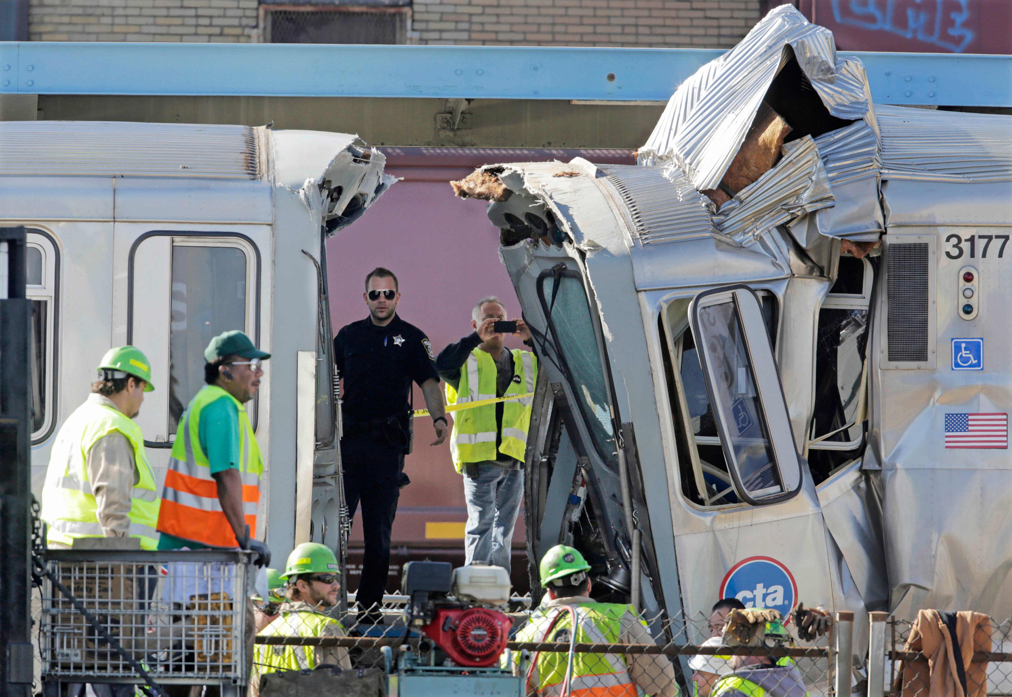 Authorities inspect the wreckage of two Chicago Transit Authority trains that crashed Sept. 30, 2013, in Forest Park, Ill.