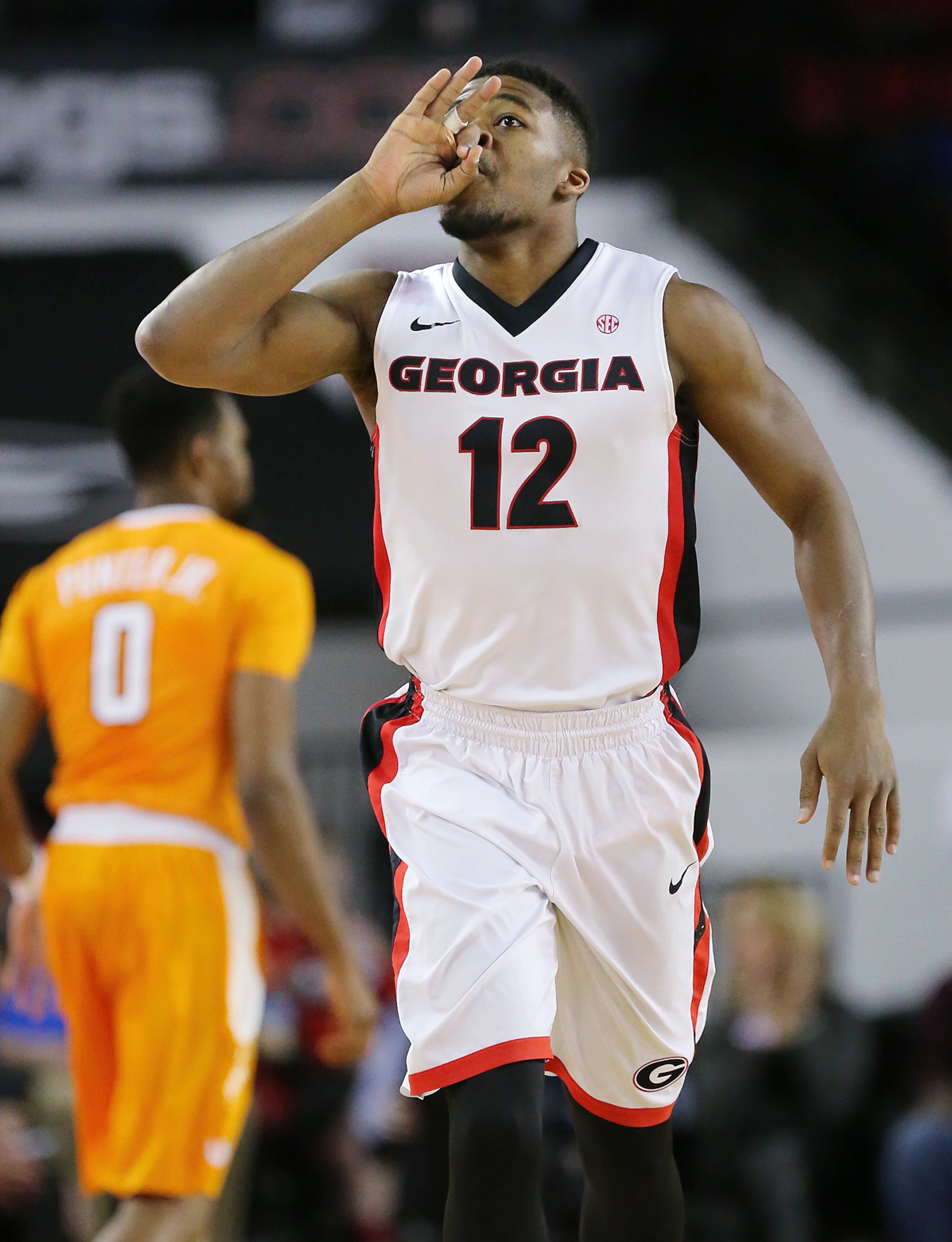 Georgia guard Kenny Gaines reacts to hitting a three against Tennessee guard Kevin Punter in a basketball game on Wednesday, Jan. 13, 2016, in Athens. Curtis Compton / ccompton@ajc.com