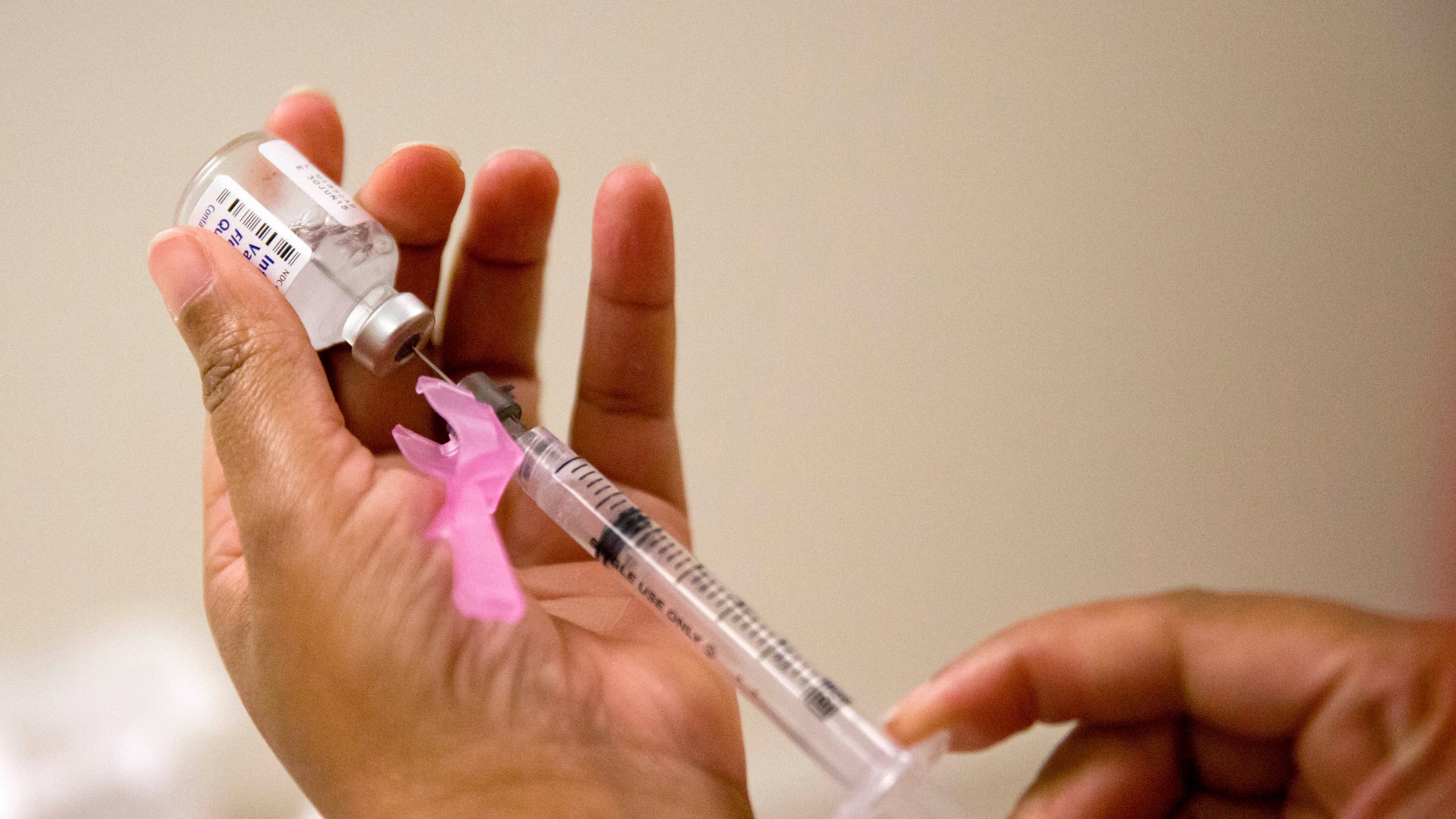 FILE - In this Feb. 7, 2018 file photo, a nurse prepares a flu shot at the Salvation Army in Atlanta. (AP Photo/David Goldman, File)