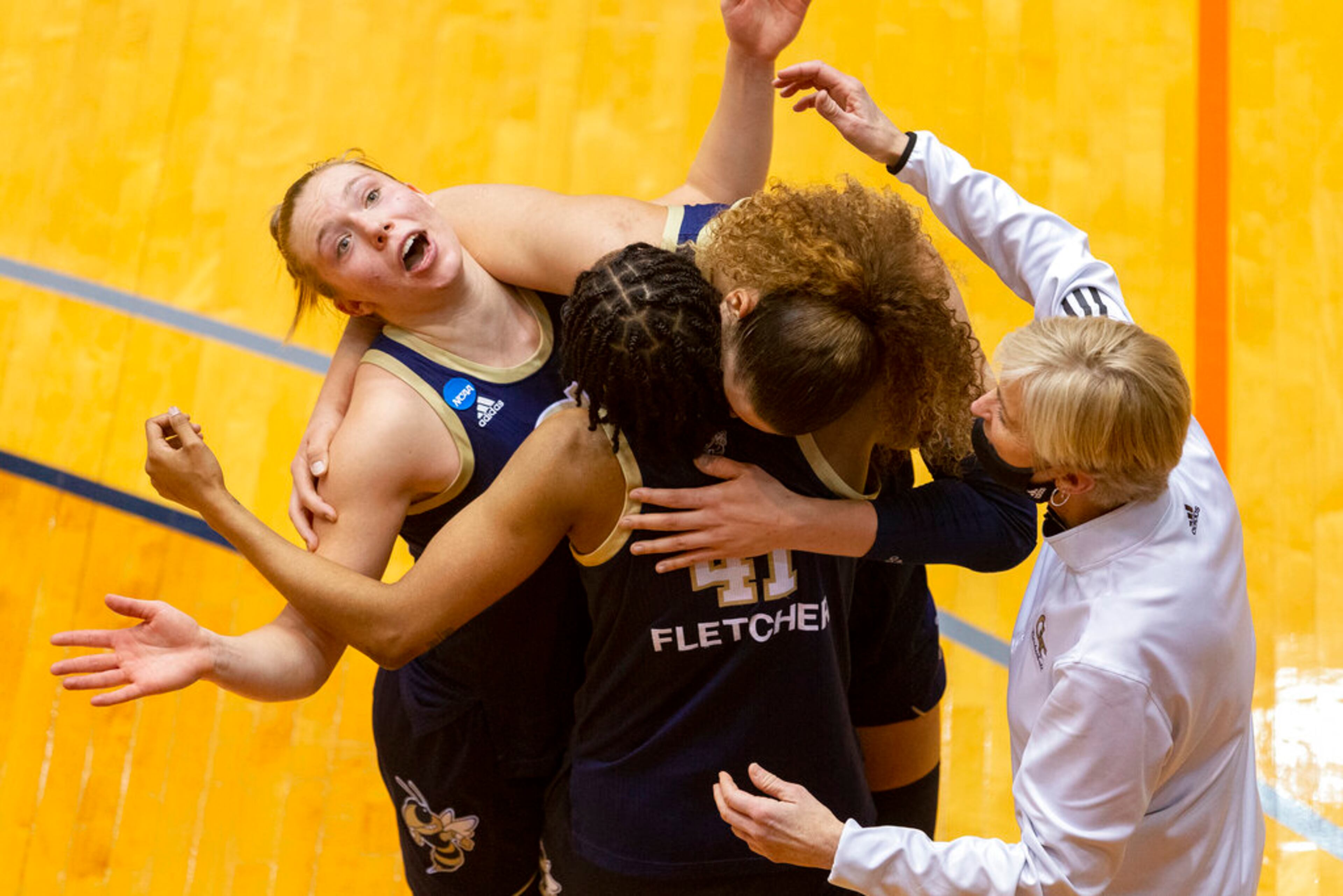 Georgia Tech guard Lotta-Maj Lahtinen, left, and teammates celebrate a 73-56 win over West Virginia with coach Nell Fortner, right, after a college basketball game in the second round of the NCAA women's tournament at the UTSA Convocation Center in San Antonio on Tuesday, March 23, 2021. (AP Photo/Stephen Spillman)